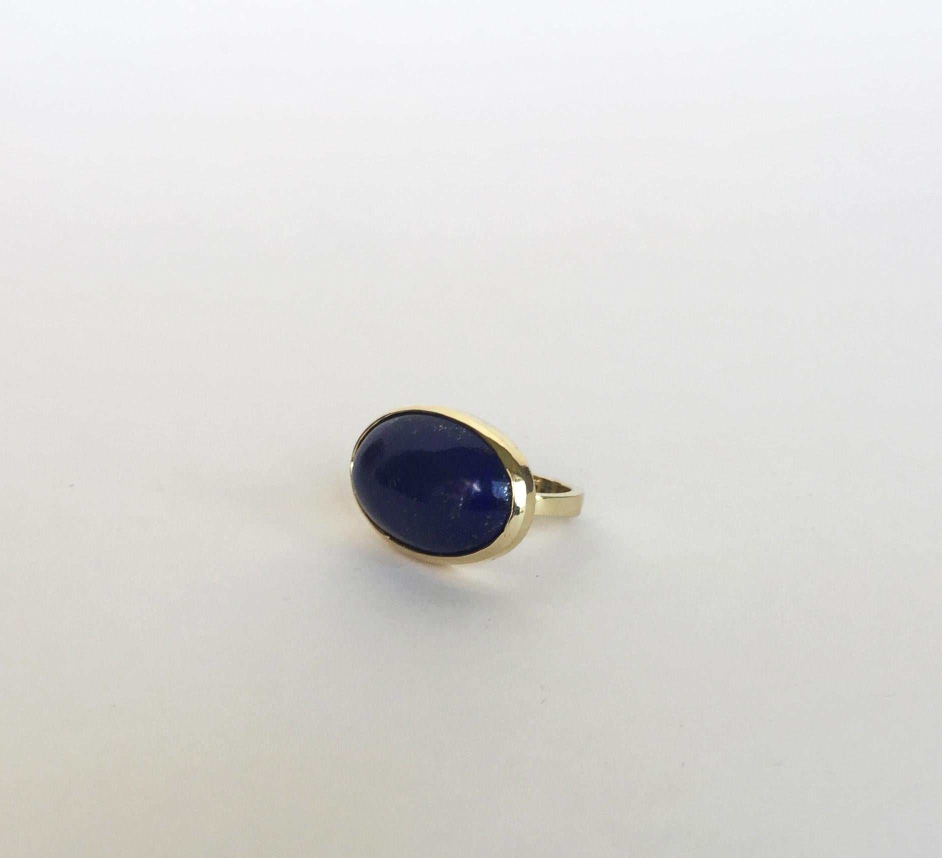 This lapis lazuli ring with 14k yellow gold setting and ring (size 7) is elegant with clean and modern lines. The royal blue of the lapis lazuli is complemented with by beautiful 14 yellow gold setting and ring. At size 7 this ring fits comfortably