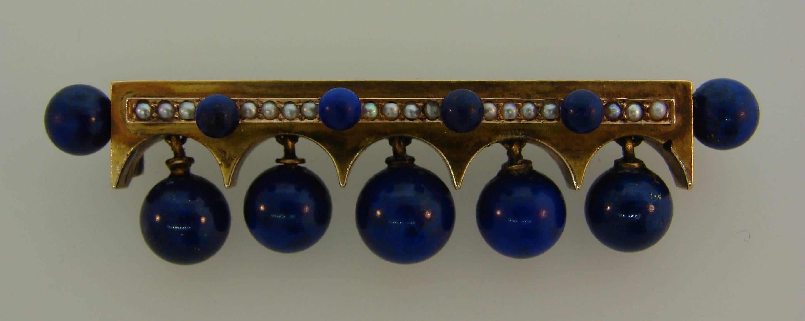 Fabulous Victorian pin, created in Europe on the turn of the 19th century. Well proportioned and wearable, the brooch is a great addition to your jewelry collection. 
Made of 15 karat (tested) yellow gold, lapis lazuli beads and seed pearls.
It
