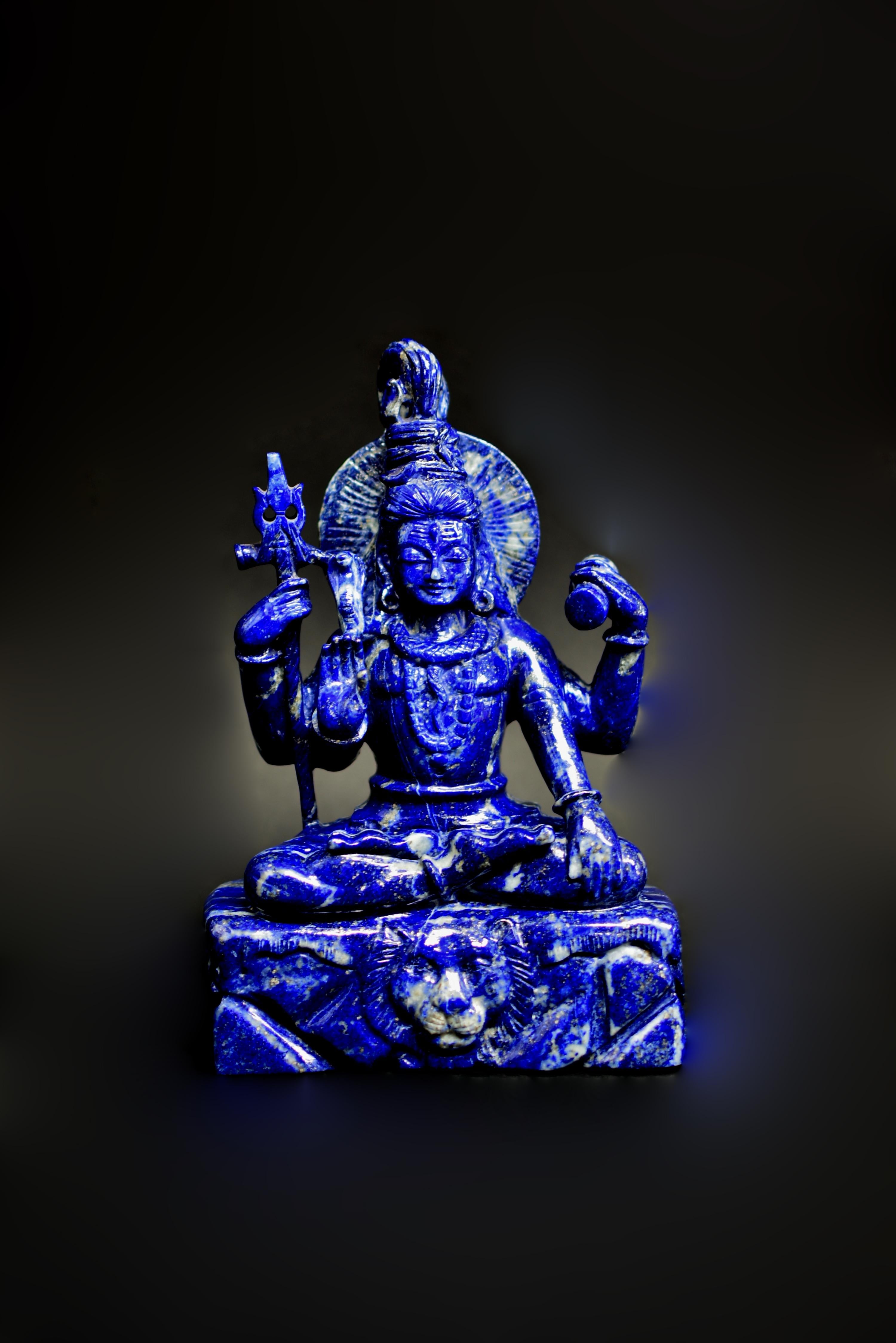 A rare 8.5 lb all natural lapis lazuli statue of Shiva, one of the most worshipped Hindu Gods. Hand carved by a master Indian artist, using the finest lapis lazuli gemstone with the most saturated, brilliant cobalt blue. Seated dyana asana on a