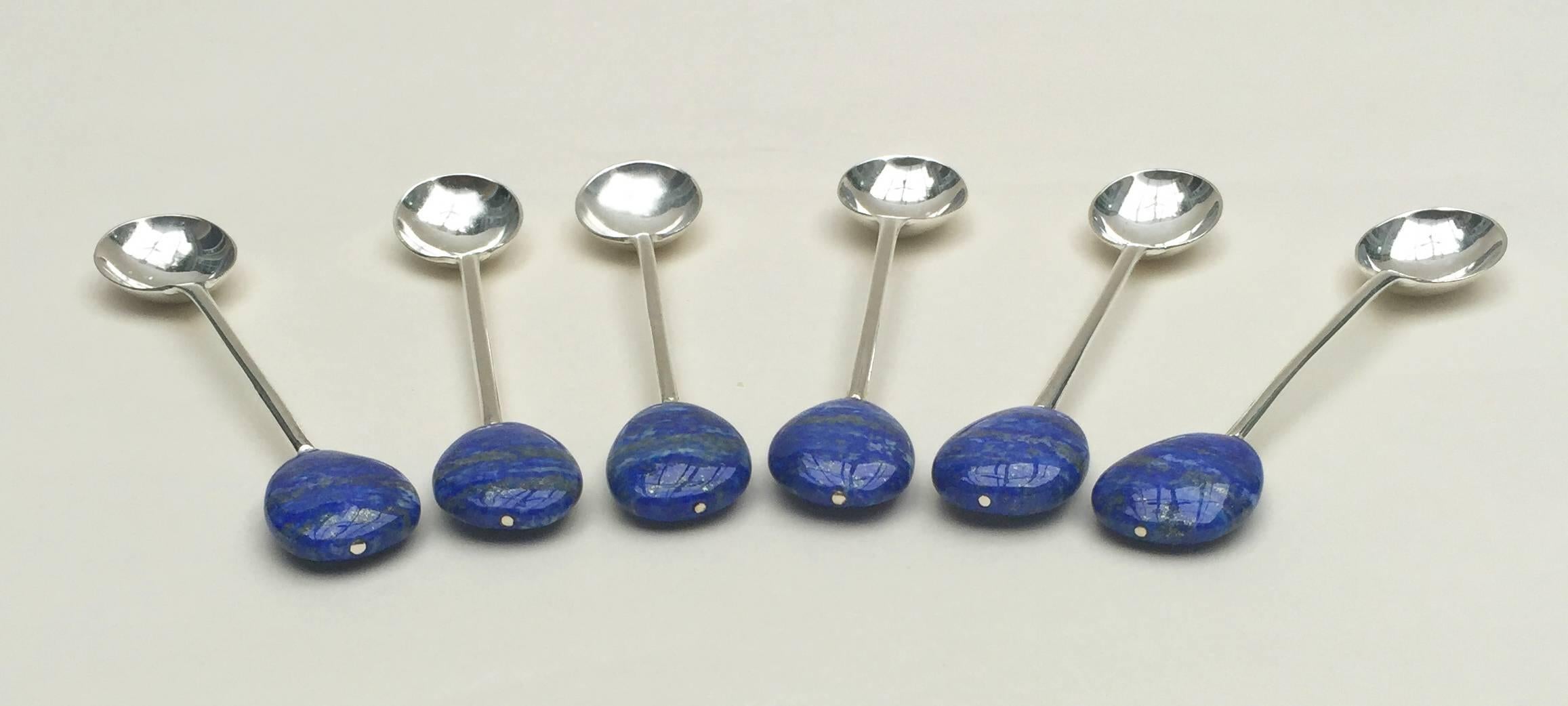 Amazing One of a Kind Spoon Set by Marina J. Each spoon in this set of 6 is composed of clean and graceful lines giving this elegant set a modern flare. The lapis lazuli beads attached to the ends are rich with deep royal blues that enhance the