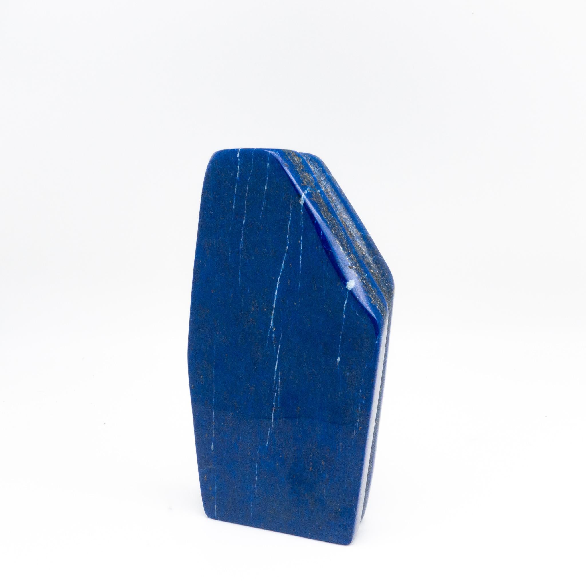Beautifully polished lapis lazuli mineral specimen from Afghanistan. This semi-precious stone has been prized since antiquity due to its intense, beautiful blue coloring and golden speckles. It was also used in the fine arts, in a crushed powder