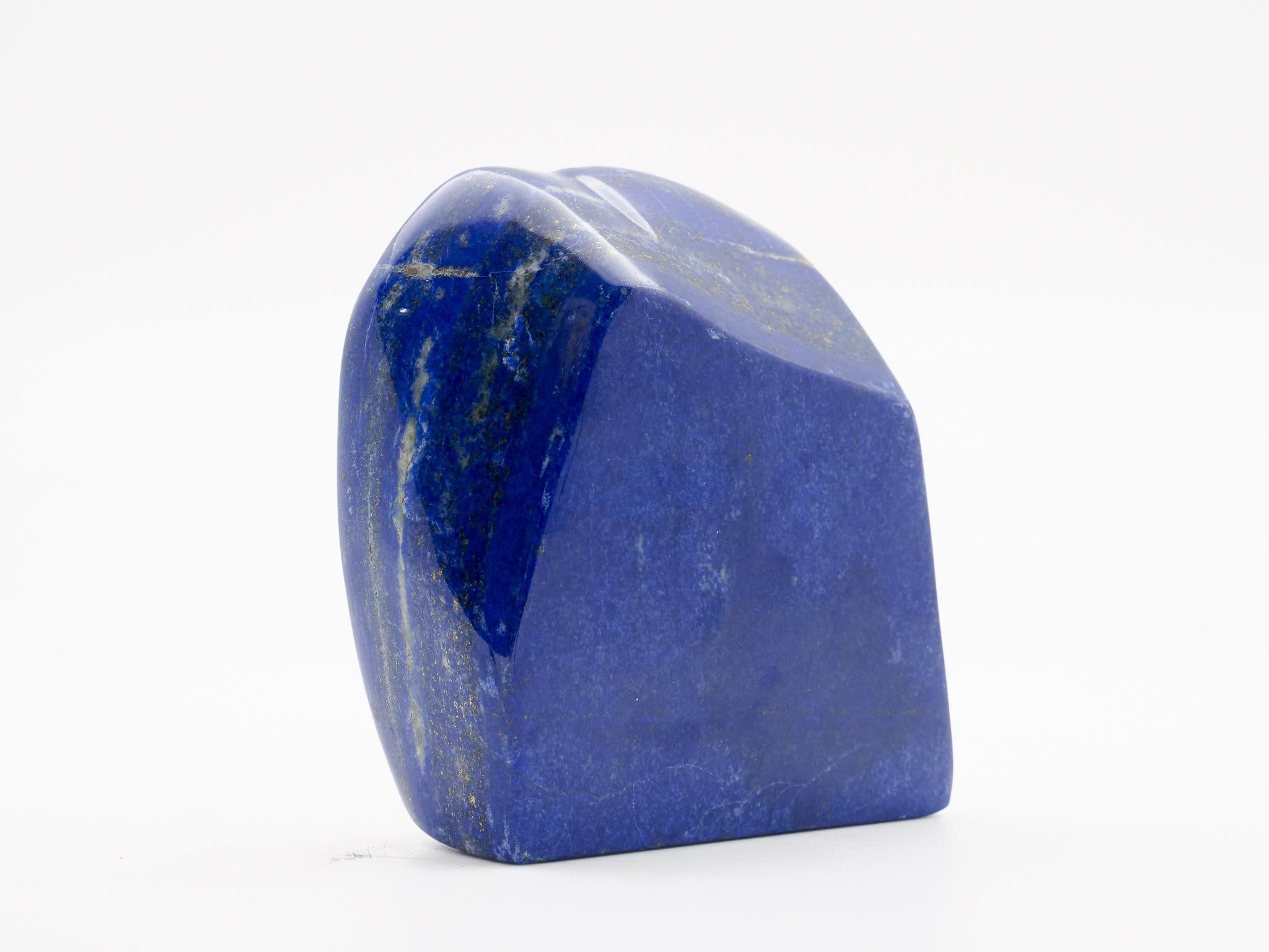 Beautifully polished lapis lazuli mineral specimen from Afghanistan. This semi-precious stone has been prized since antiquity due to its intense, beautiful blue coloring and golden speckles (pyrite flecks). It was also used in the fine arts, in a
