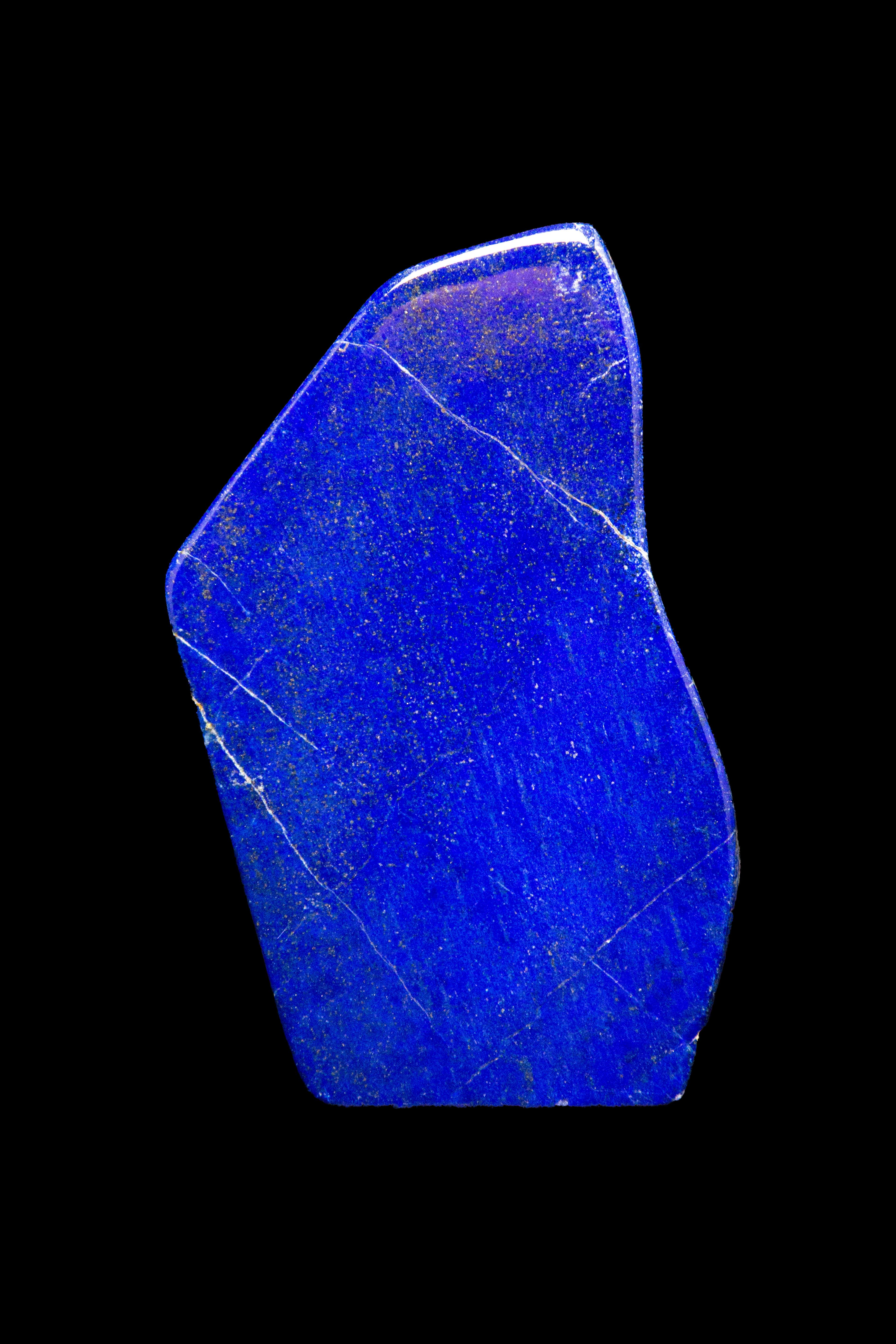 Beautifully polished lapis lazuli mineral specimen from Afghanistan. This semi-precious stone has been prized since antiquity due to its intense, beautiful blue coloring and golden speckles. It was also used in the fine arts, in a crushed powder