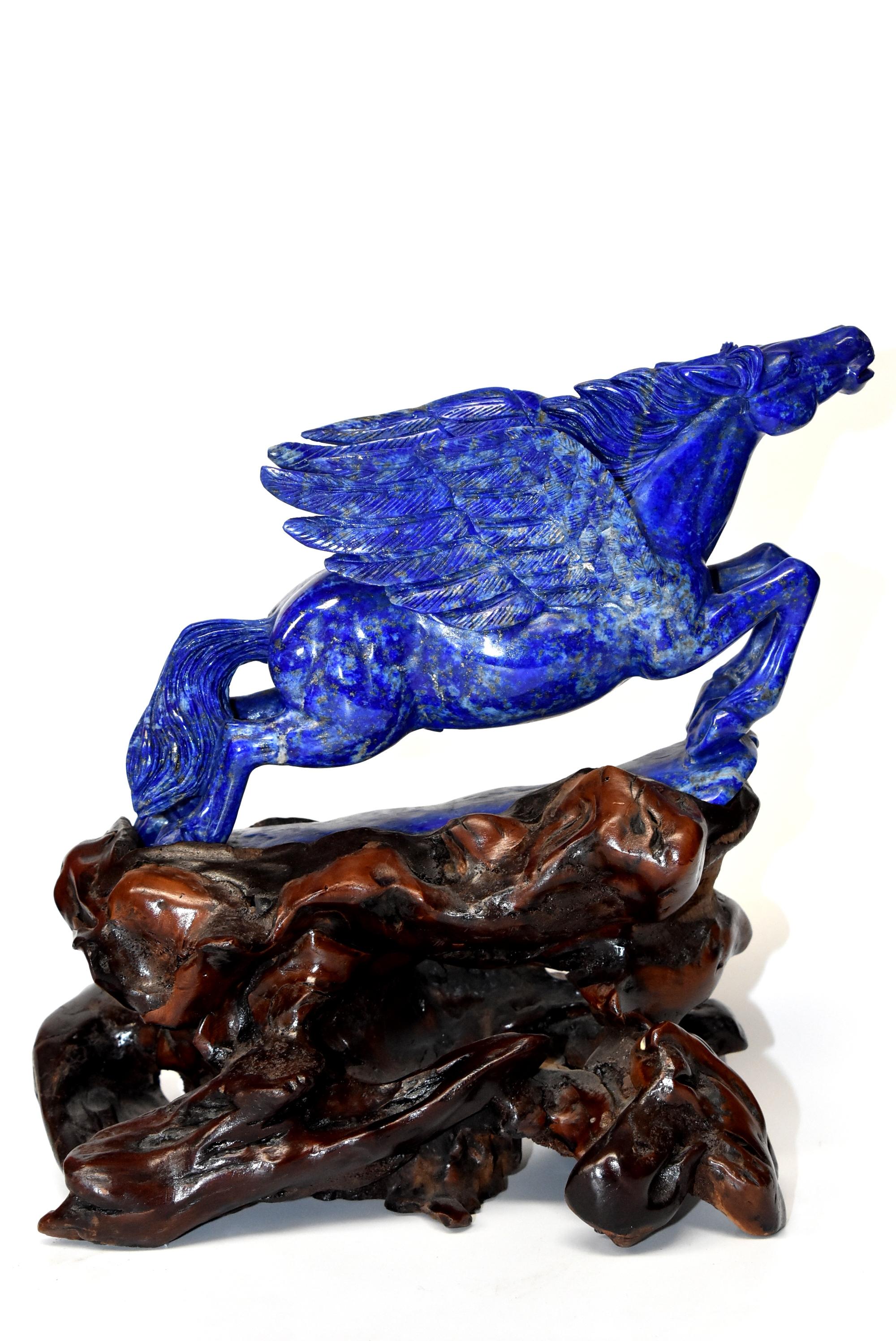 An absolutely stunning all natural lapis lazuli Pegasus sculpture. The 4.5 lb stone is a brilliant royal blue with beautiful glittering of gold and white snow spots. Fantastic work done by a locally renowned sculptor, Shi Dan Xiu. He is known for