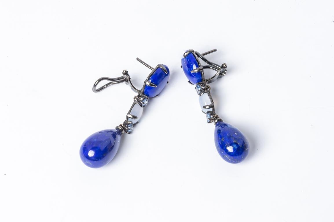 Discover these beautiful, exquisite earrings that elegantly combine lapis lazuli, chalcedony, tanzanite and a sumptuous black gold plating. Their creations are the result of meticulous craftsmanship, showcasing a black gold setting, delicately