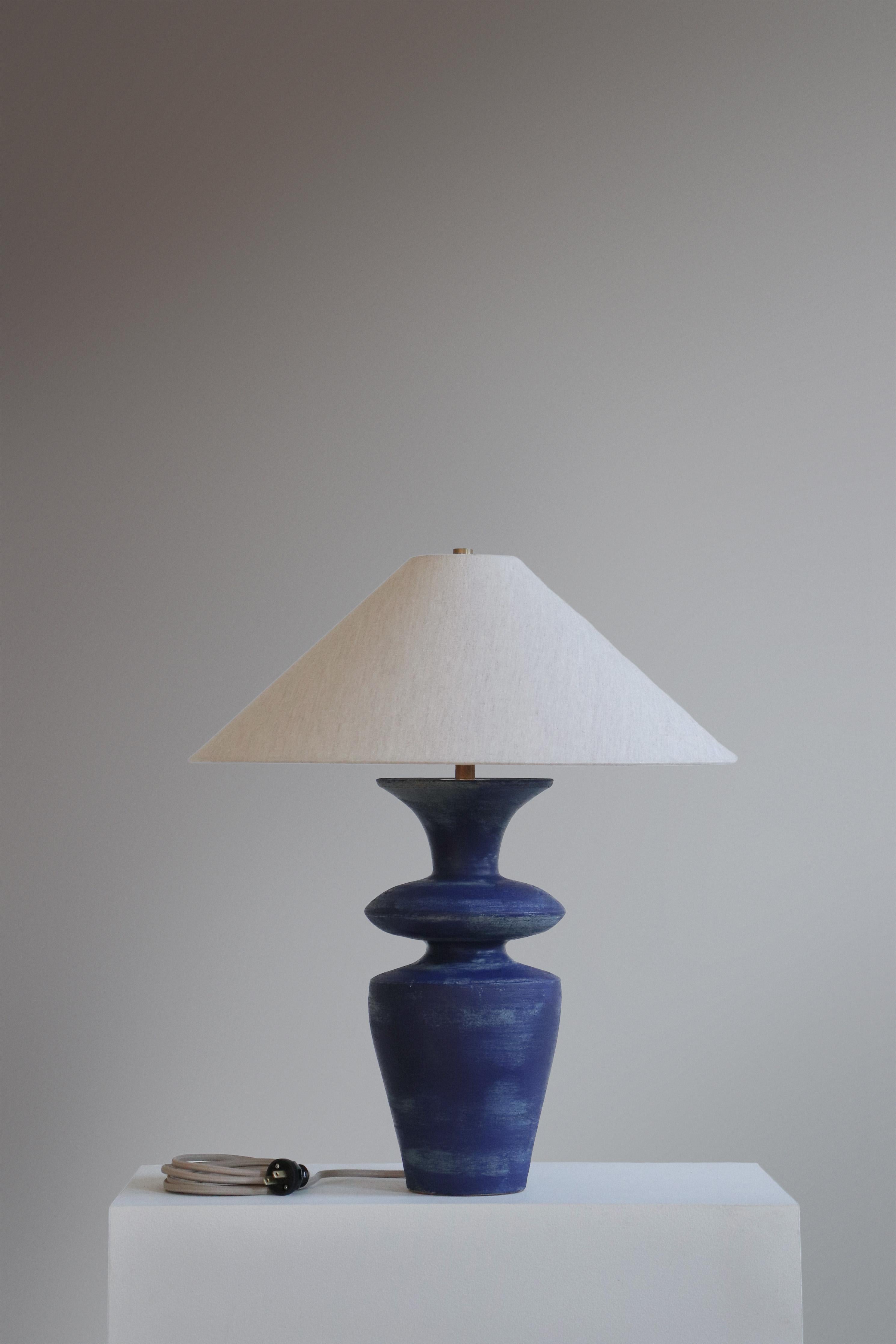 Lapis Rhodes Table Lamp by Danny Kaplan Studio
Dimensions: ⌀ 51 x H 69 cm
Materials: Glazed Ceramic, Unfinished Brass, Linen

This item is handmade, and may exhibit variability within the same piece. We do our best to maintain a consistent product,