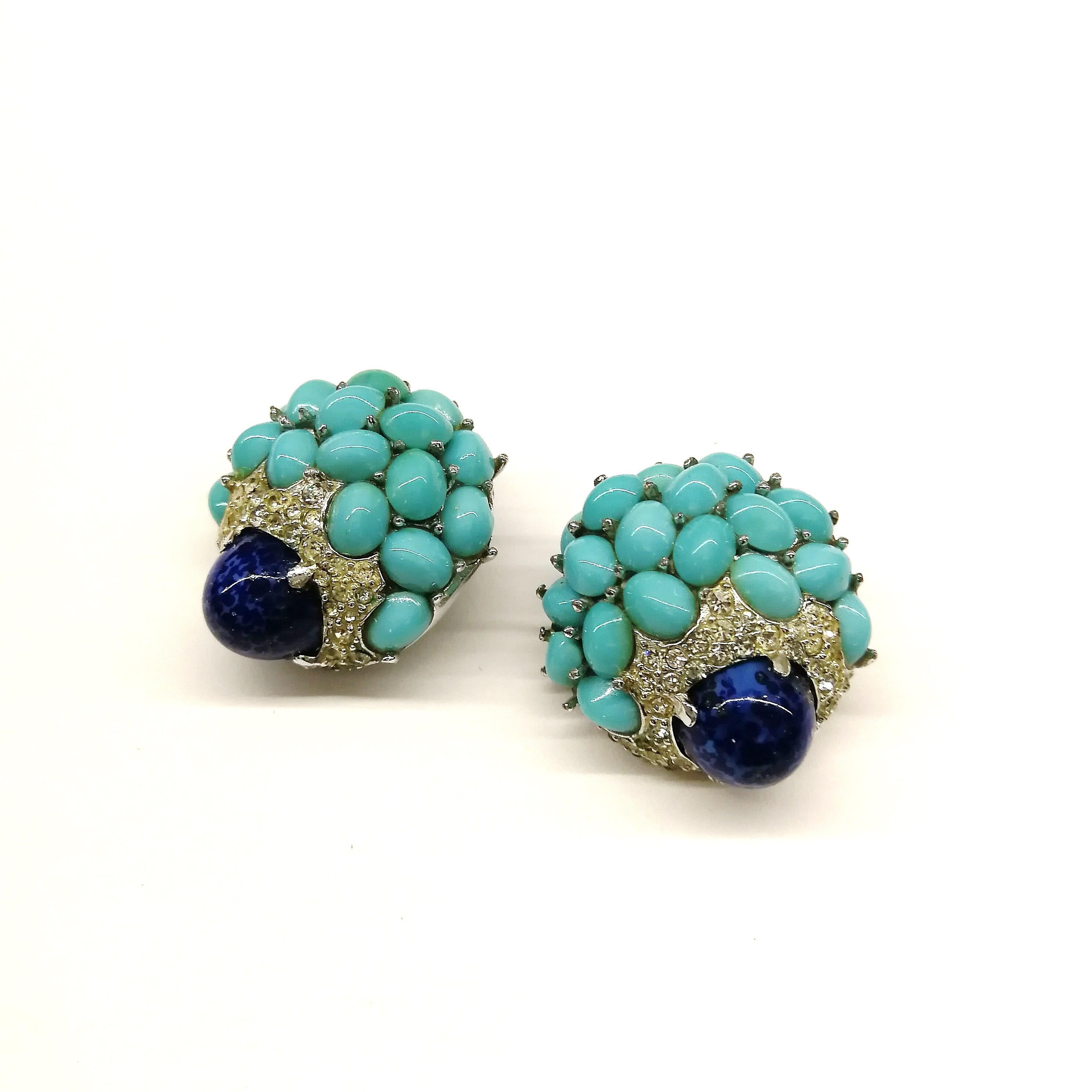 A beautiful pair of 'cluster' earrings, with turquoise cabochons, and a large lapis 'bullet' cabochon at the centre of each earring, highlighted all round with clear pastes. Echoing designs from Cartier and Van Cleef And Arpels of the same period,