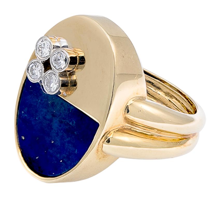 An oval design ring containing a semi- oval lapis lazuli on its other half and polished gold and diamonds on the other. This Modernist style highlights a very unique design. There are 4 round brilliant cut white diamonds that are bezel-set in a cube
