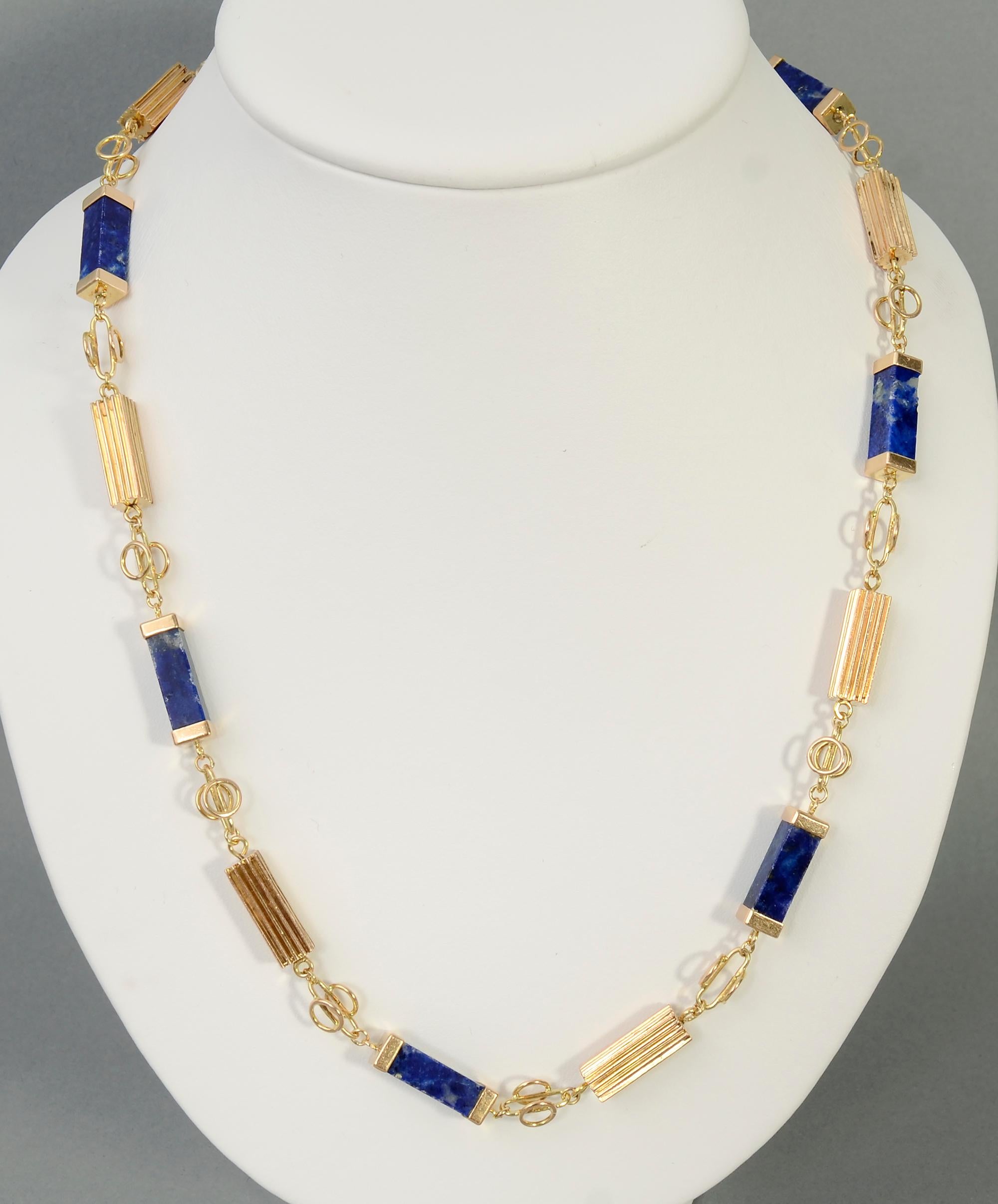 Handmade Retro long gold chain necklace with rectangles of lapis lazuli. Circles and ovals make for an interesting gold link. Each piece of lapis is 1/4
