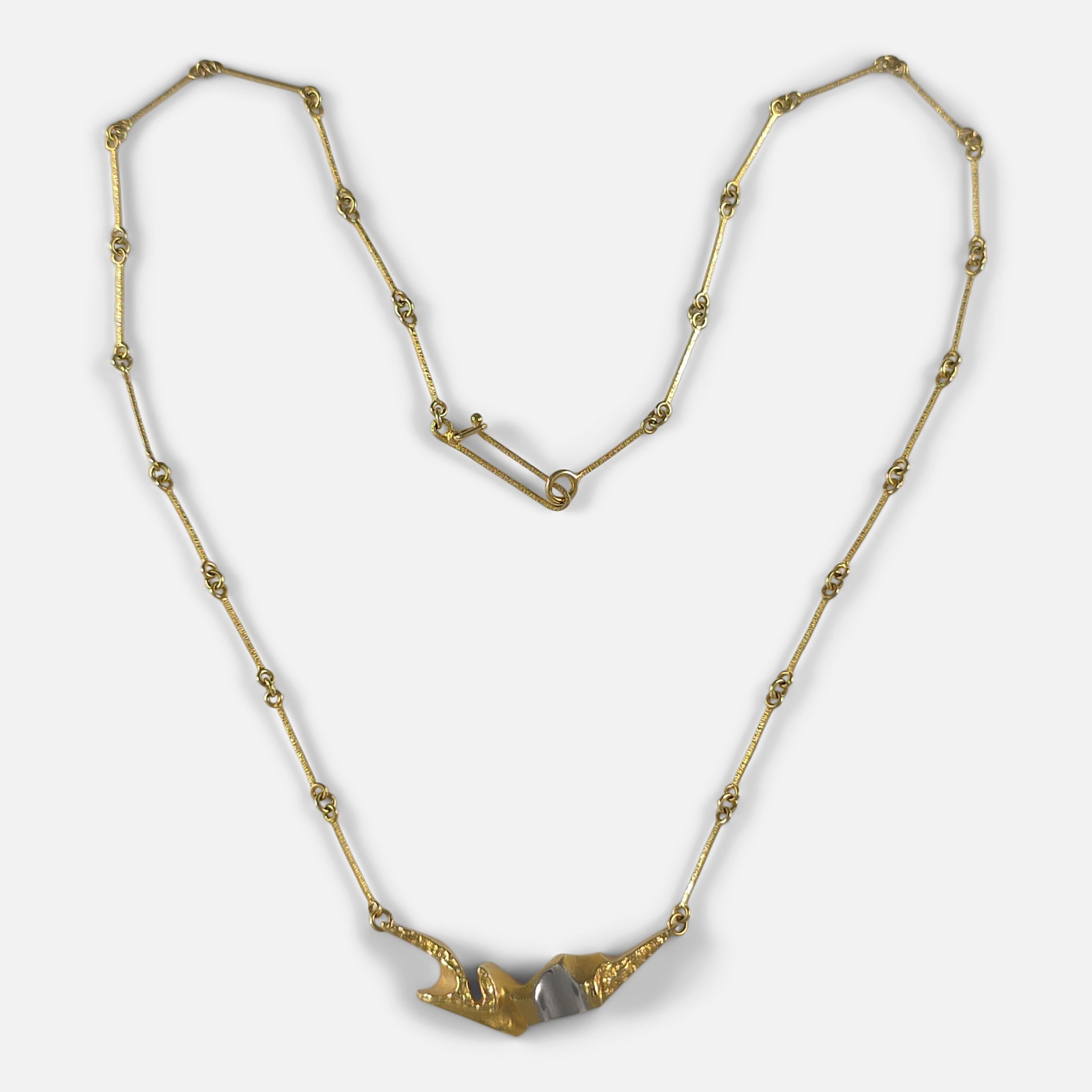 An elegant Lapponia necklace featuring an 18ct yellow and white gold pendant, designed by Björn Weckström.

• Assay: Marked '750' indicating 18 carat gold, with the Lapponia maker's icon and Finnish date mark 'K8'.
• Period: Late 20th century.
•