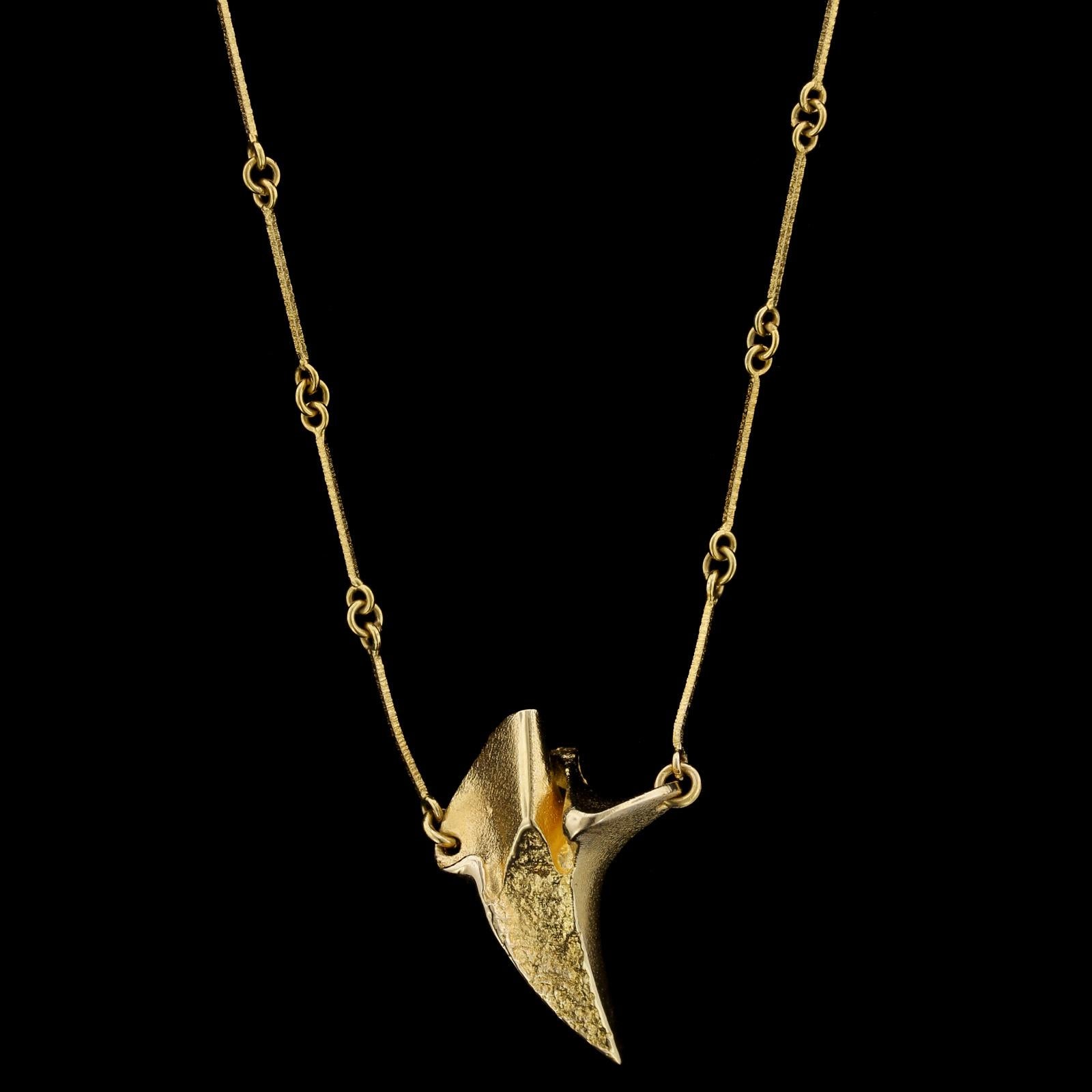 Lapponia 18K Yellow Gold Necklace, Finland. The abstract pendant is completed
by textured bar links, length 17