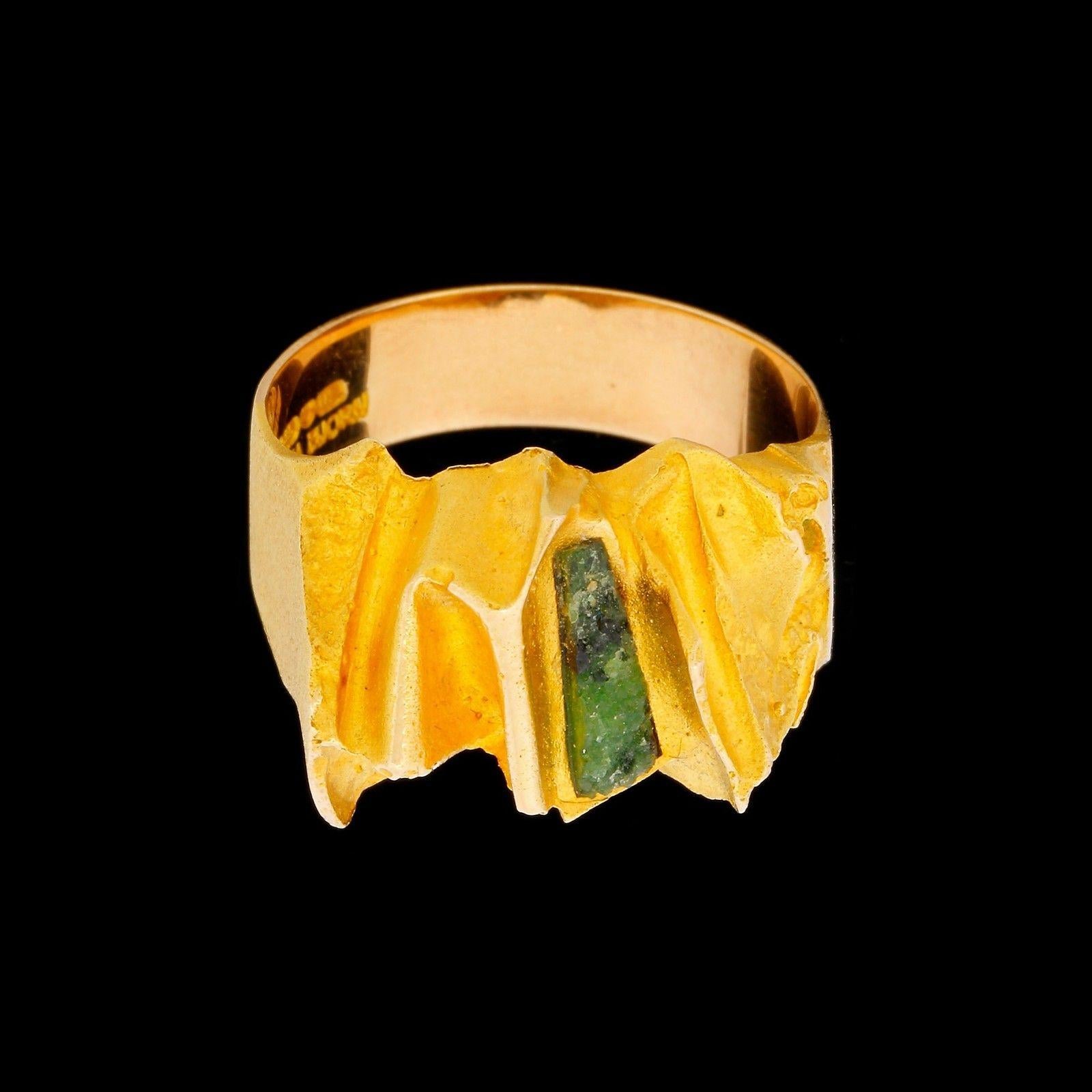 Very fine Brutalist Movement 14k Yellow Gold and Green Tourmaline Rough unisex ring designed by Bjorn Weckstrom Lapponia from Helsinki, Finland, in 1973. 
This amazing vintage Lapponia ring has a baguette shaped piece of green tourmaline which looks