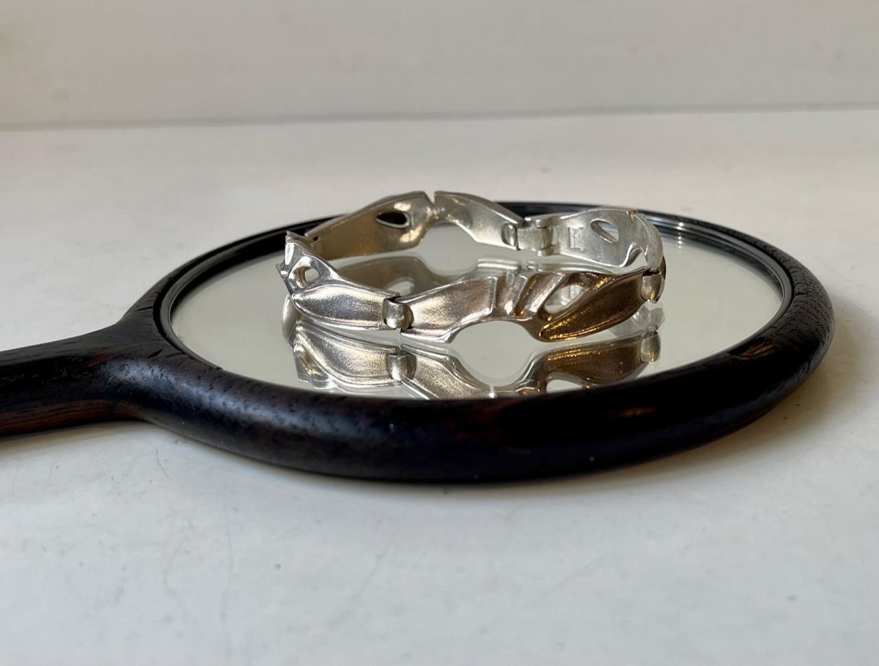 Much sought after vintage 'organic' modern sterling silver bracelet. Fully hallmarked by Lapponia, Finland. Designed during the 1970s by Bjorn Weckstrom.
Measures: Length closed: 7.1in / 18cm. Width: 14mm.


