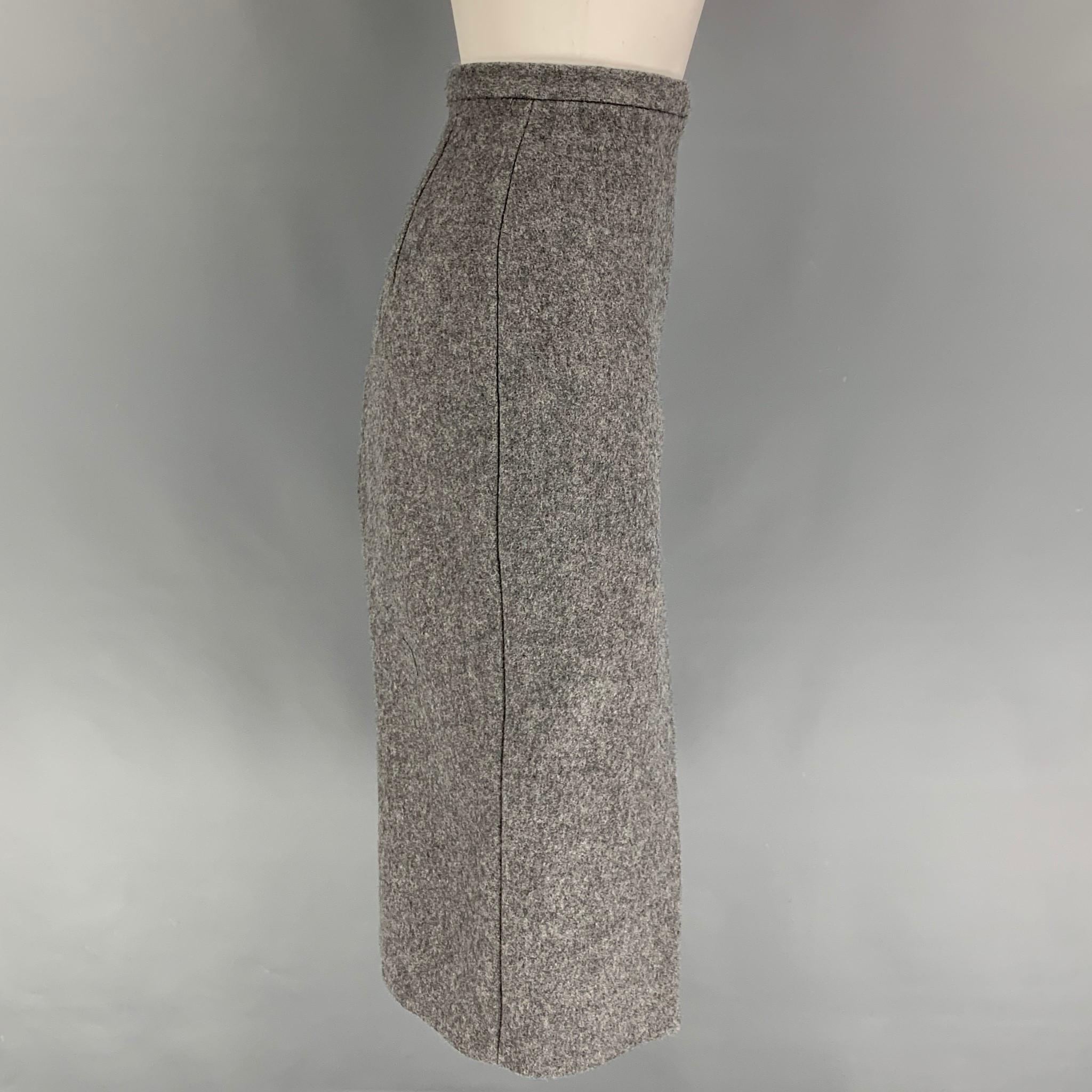 LaQuan Smith skirt comes in a grey heather wool / nylon with a slip liner featuring a high waisted style, high front slit, and a back zip up closure. Made in USA. 

Excellent Pre-Owned Condition.
Marked: XS
Original Retail Price: