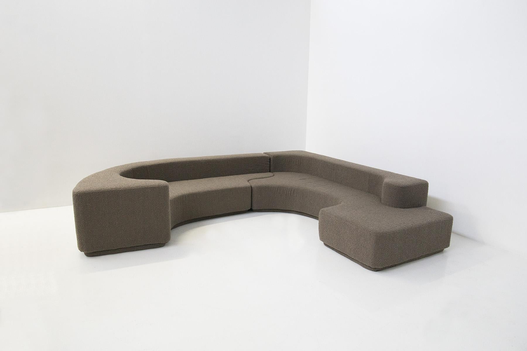 An elegant, eccentric and geometric sofa by Roberto Pamio and Renato Toso for the Stilwood manufactory from the 1960s and early 1970s. The sofa was recently restored in an elegant, soft dark grey bouclè (tending to brown). 
The sofa is the LARA