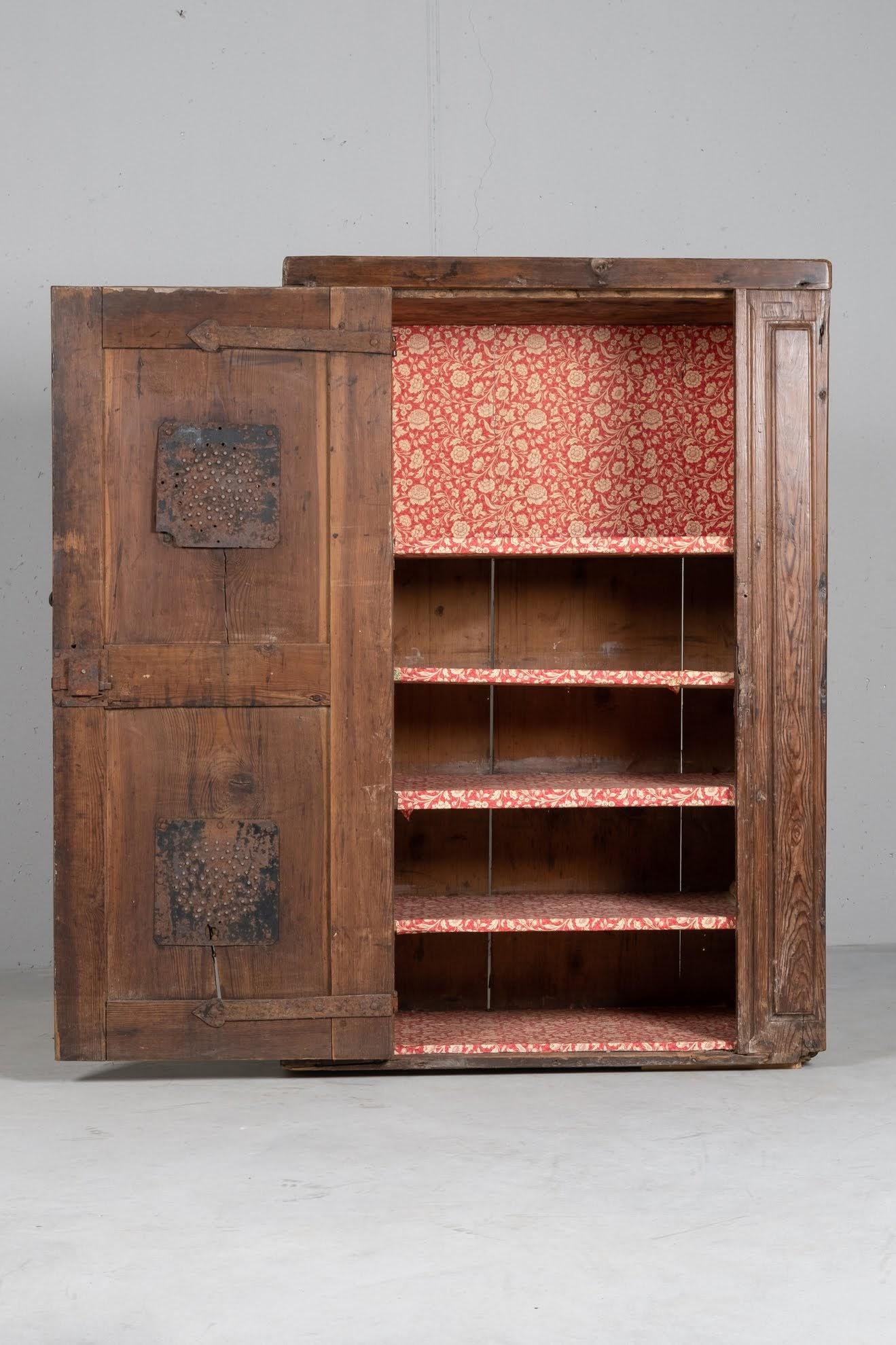 Originally built in the wall, this unique cupboard maintains an extraordinary patina, that recorded wonderfully over 400 years of history.