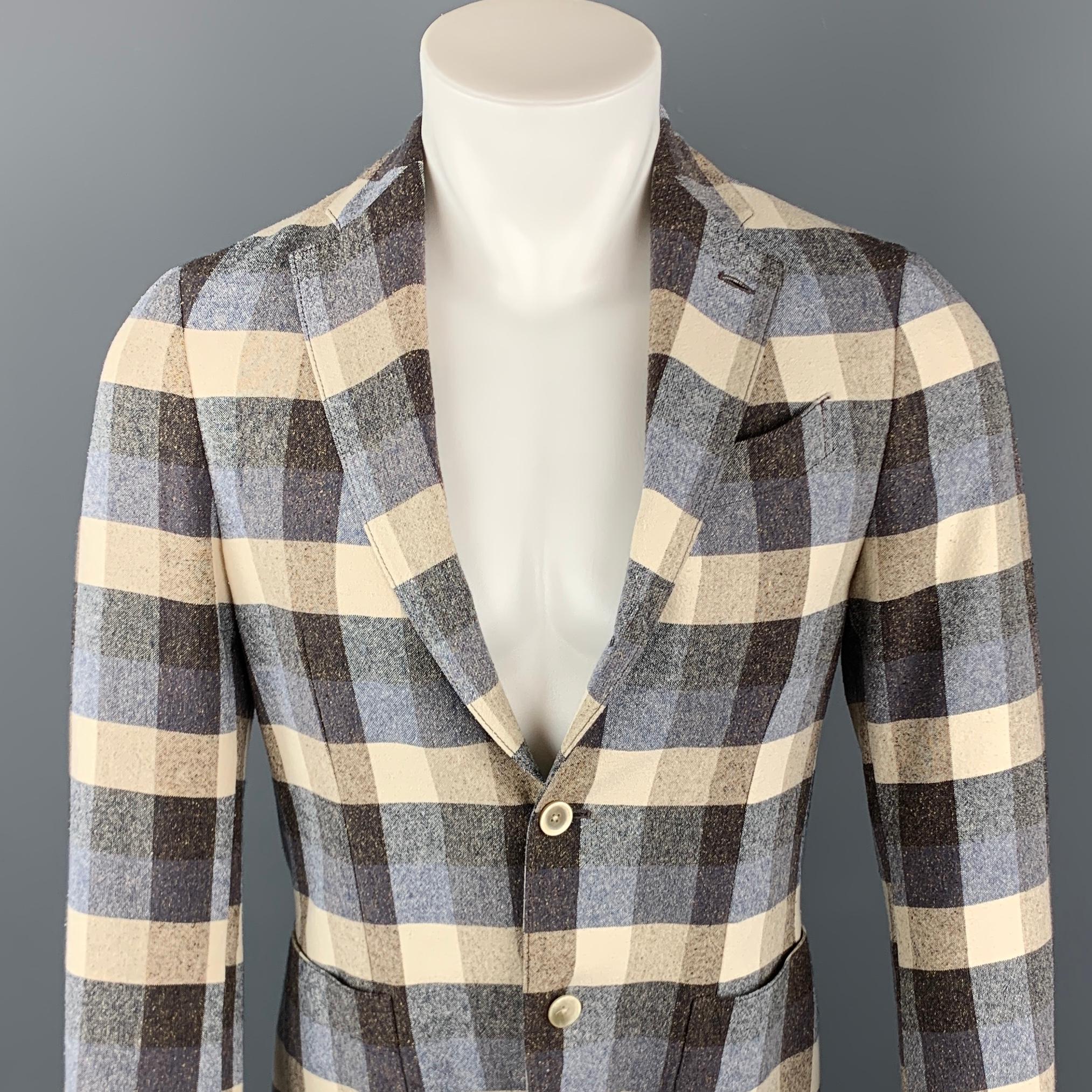 LARDINI sport coat comes in a navy & brown checkered wool / polyester featuring a peak lapel, patch pockets, and a two button closure. Made in Italy.

Excellent Pre-Owned Condition.
Marked: 44

Measurements:

Shoulder: 15 in.
Chest: 36 in.
Sleeve:
