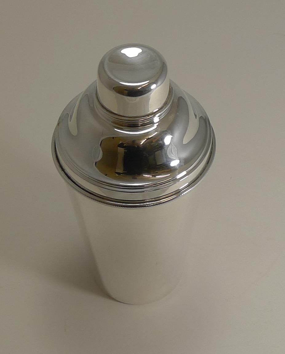 A wonderful large sized one and a half pint cocktail shaker in silverplate. Highly desirable, this one has an integral ice breaker which is revealed once the upper portion is removed.

The underside is signed by the well renowned silversmith James