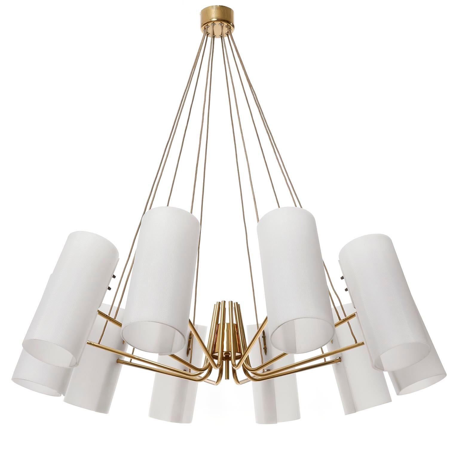An extra large 10-arm pendant chandelier manufactured in midcentury, crica 1960.
The light fixture is made of a solid, polished brass frame with curved arms suspended on cords from the ceiling canopy.
Each arm has one socket for a medium or standard