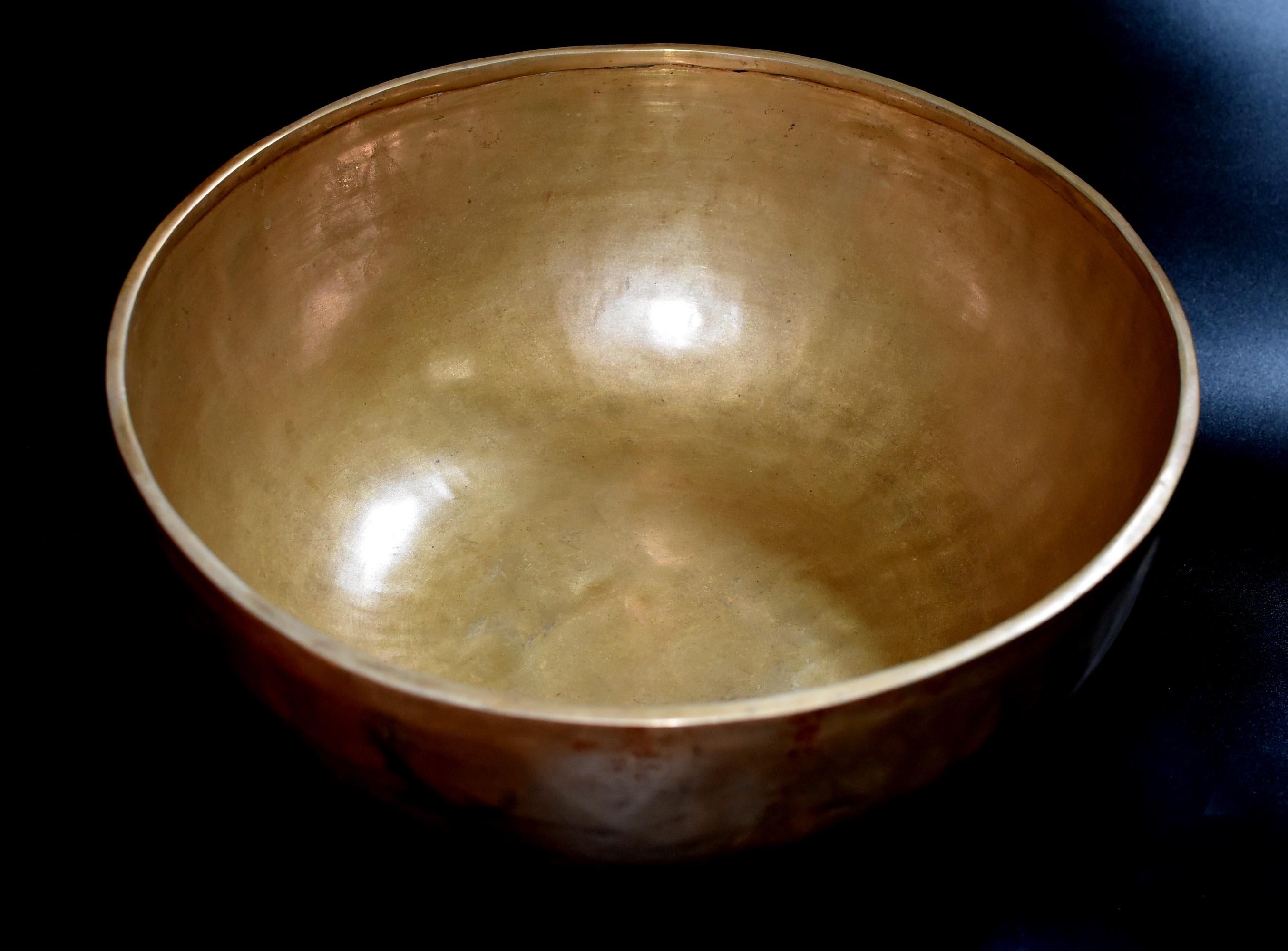 A handmade piece by the Nepalese craftsmen, hand hammered and polished to a lustrous gold tone. It produces the deepest, most calming and thought provoking sound, which only the best quality singing bowl made from the best material can produce. The