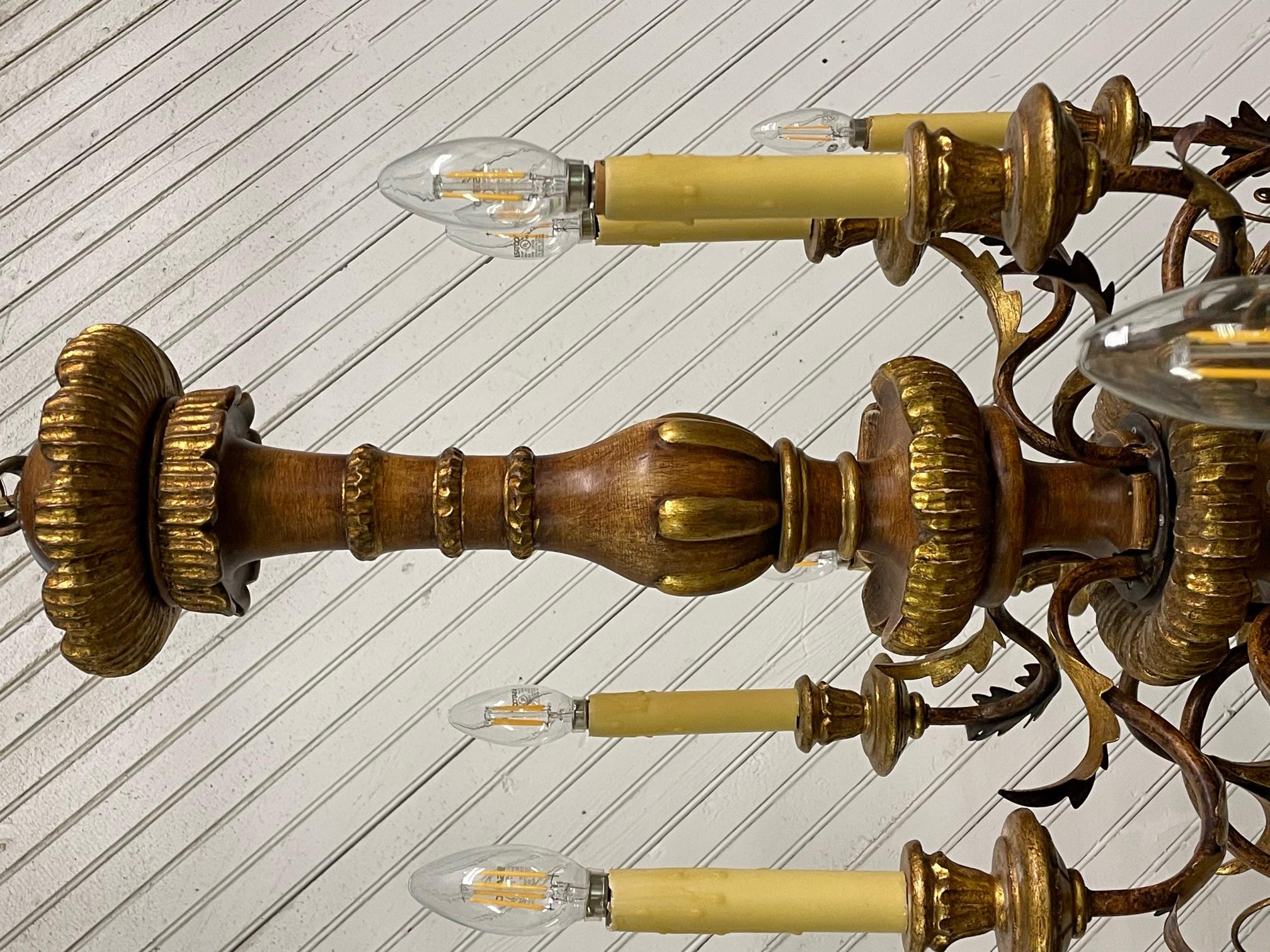 Large 12-arm chandelier features two levels of candle stye lights and tole metal accents. Good condition with minor imperfections consistent with age. Some candle sleeves show cracks along top edge.
**Please note: We offer shipping direct from our