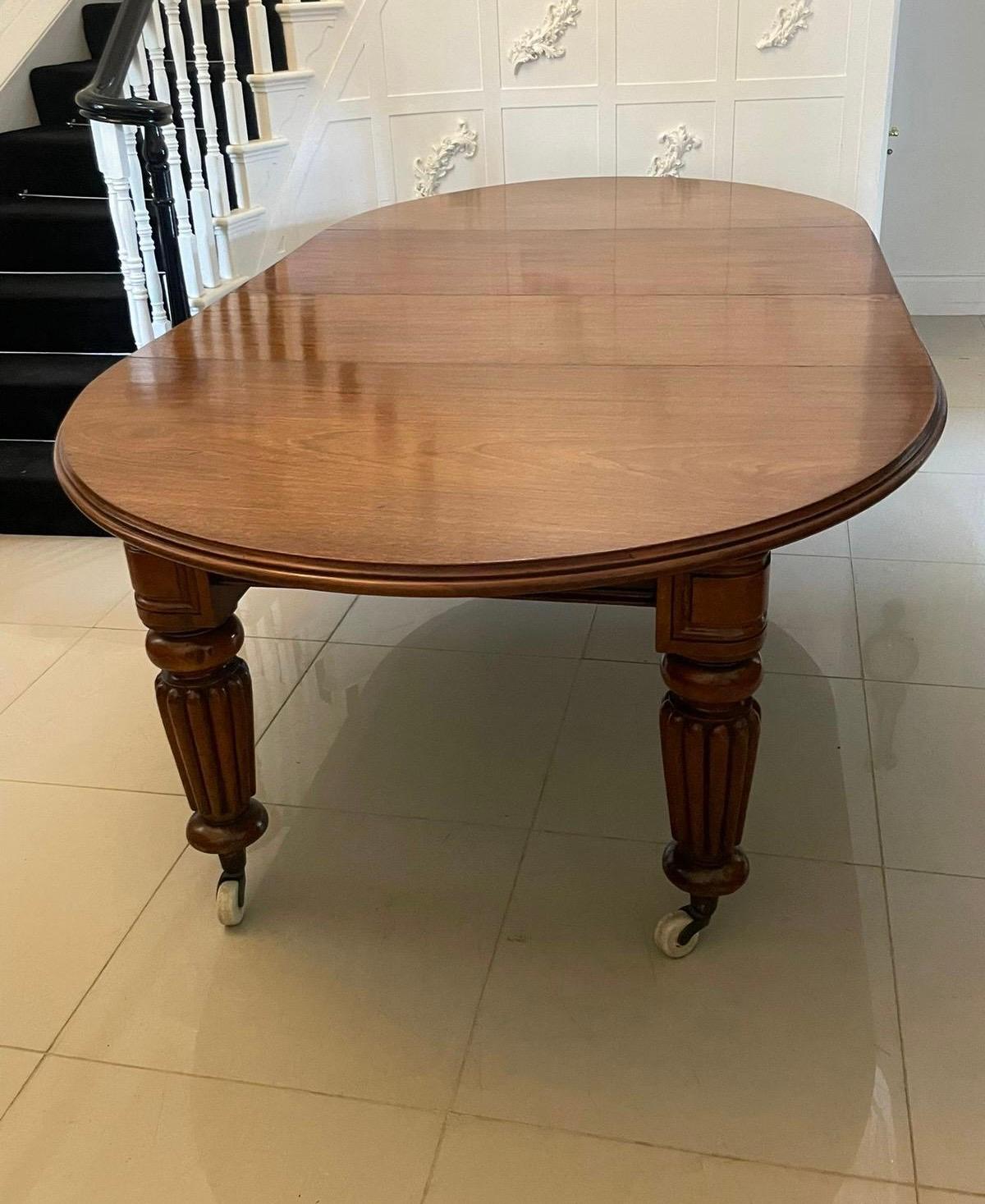 Large 12 seater Outstanding quality antique Victorian figured mahogany extending dining table having a figured mahogany oval ended extending top with a double moulded edge and two original extra leaves, original winding mechanism and handle standing