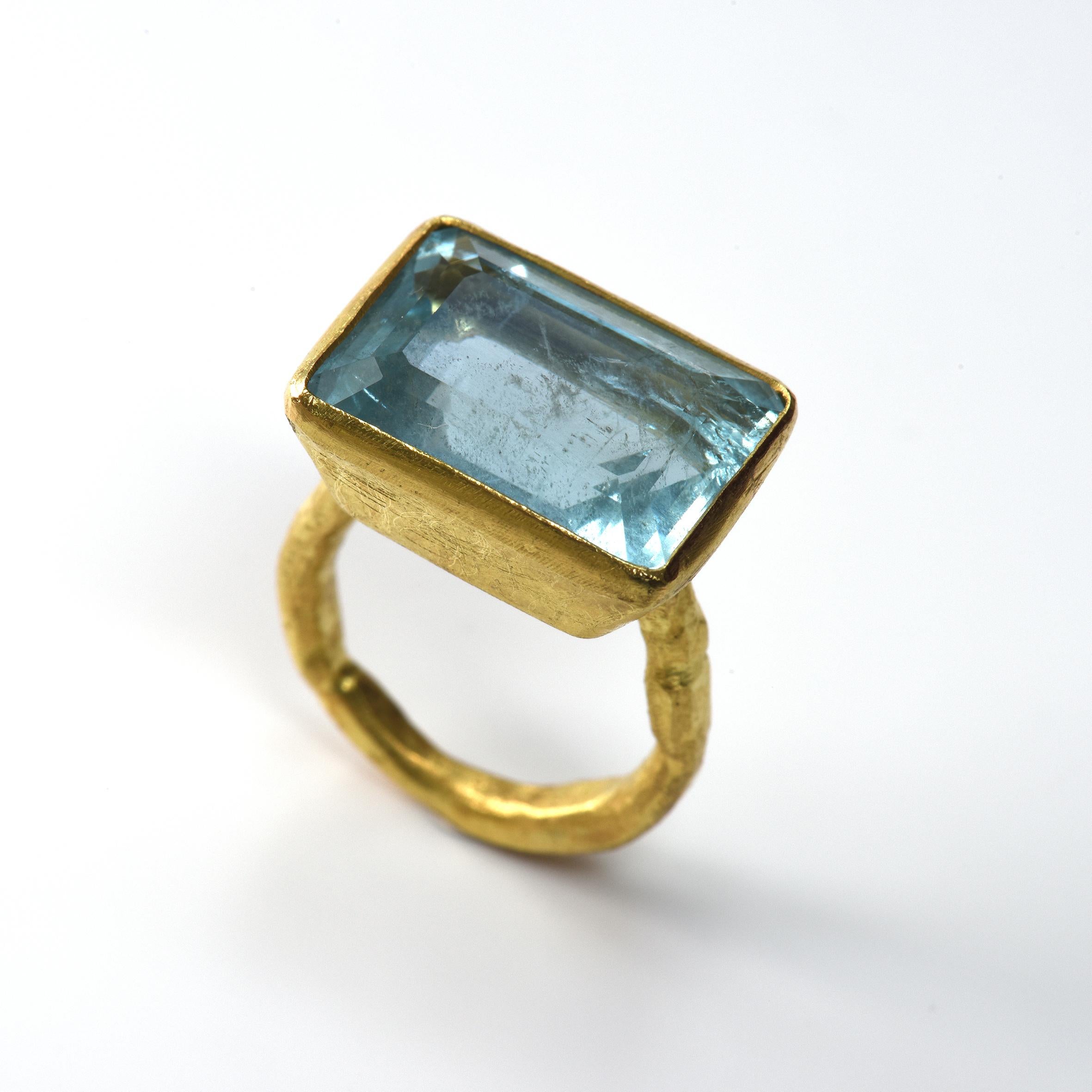 Large rectangular aquamarine, 13.68cts set in 18k yellow gold tapered rub-over setting on organic textured 18k yellow gold ring.

Disa Allsopp is an internationally renowned goldsmith based in London, UK. She is known for her use of colourful