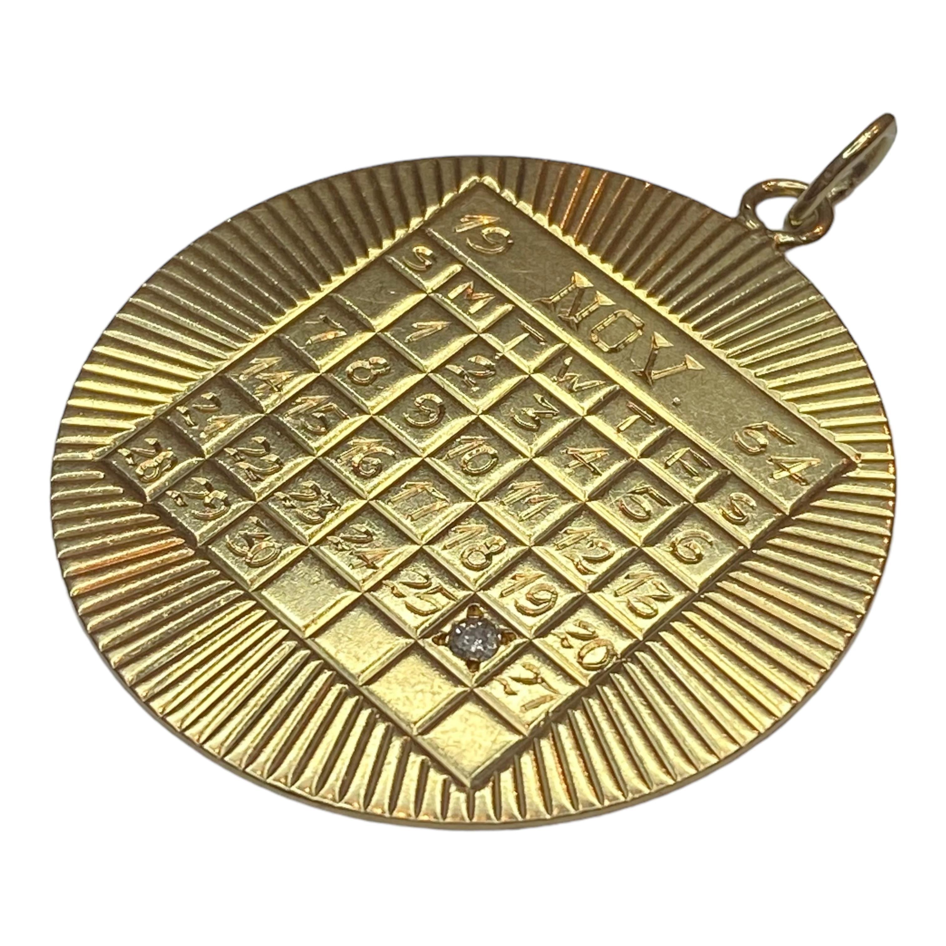 Crafted in 14K yellow gold, the pendant features the engine turn lines with a calendar in the center. The calendar is for the month of November, 1954.
A single diamond is set in the 26th day. Hand engraved GSH initials on the back.
Measurements: 48