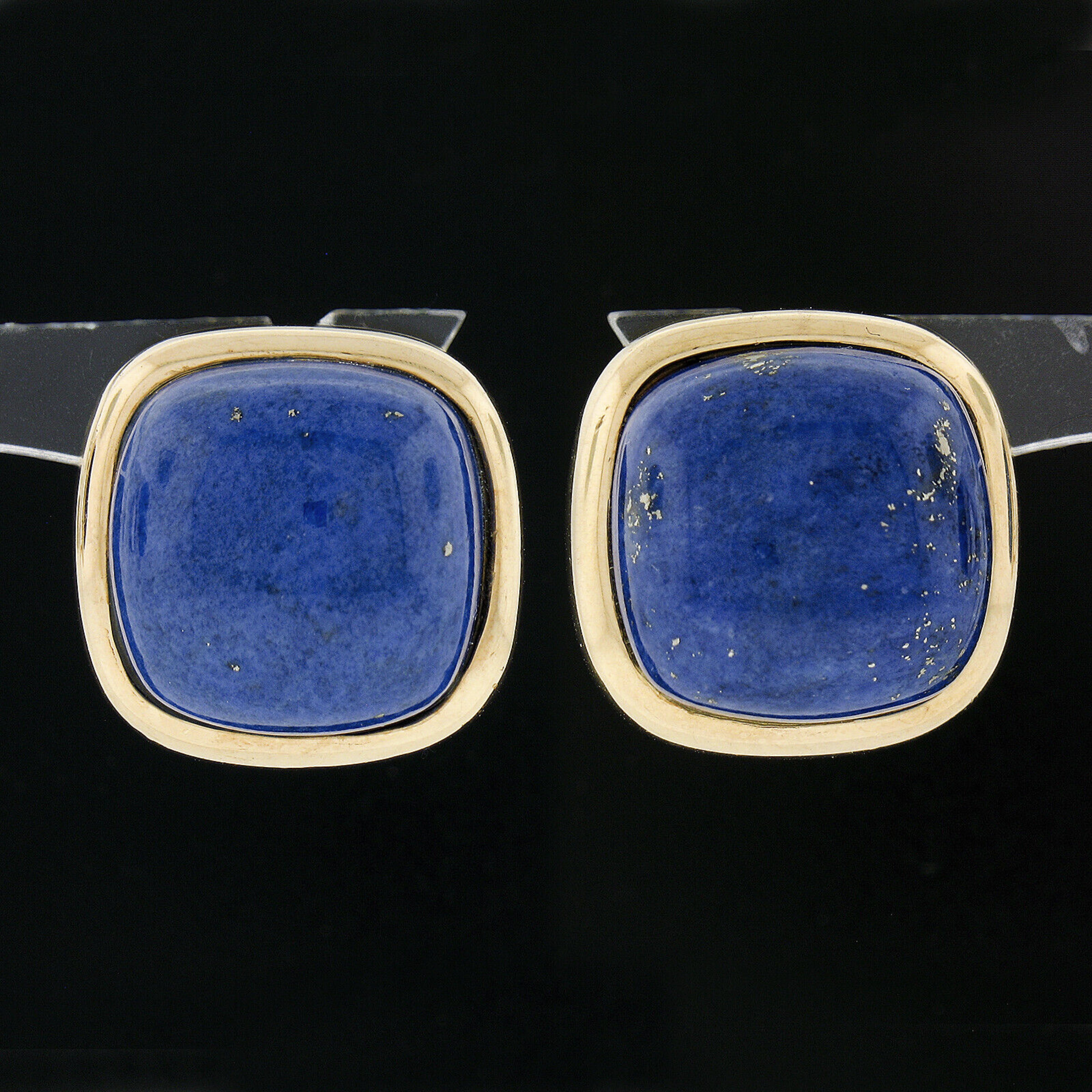 These beautiful button earrings are very well crafted in solid 14k yellow gold and feature a pair of absolutely gorgeous lapis stones. These large and very fine quality lapis are cushion cabochon cut and are neatly bezel set at the center of a high