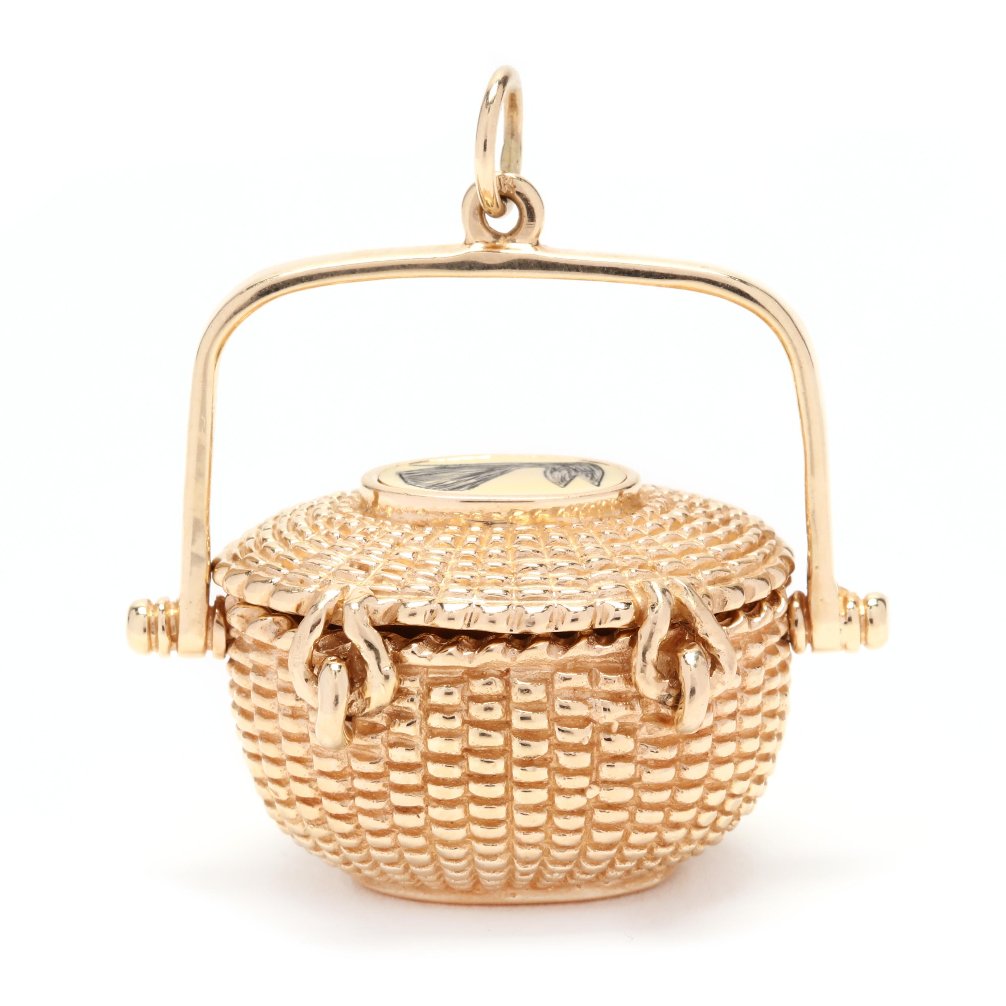 A large 14 karat yellow gold whale nantucket basket charm / pendant. An oval, rope basket motif with an articulated lid that snaps in place and an etched whale motif on top, as well as a polished handle. Signed and stamped 1977.

Length: 1 7/16 in.