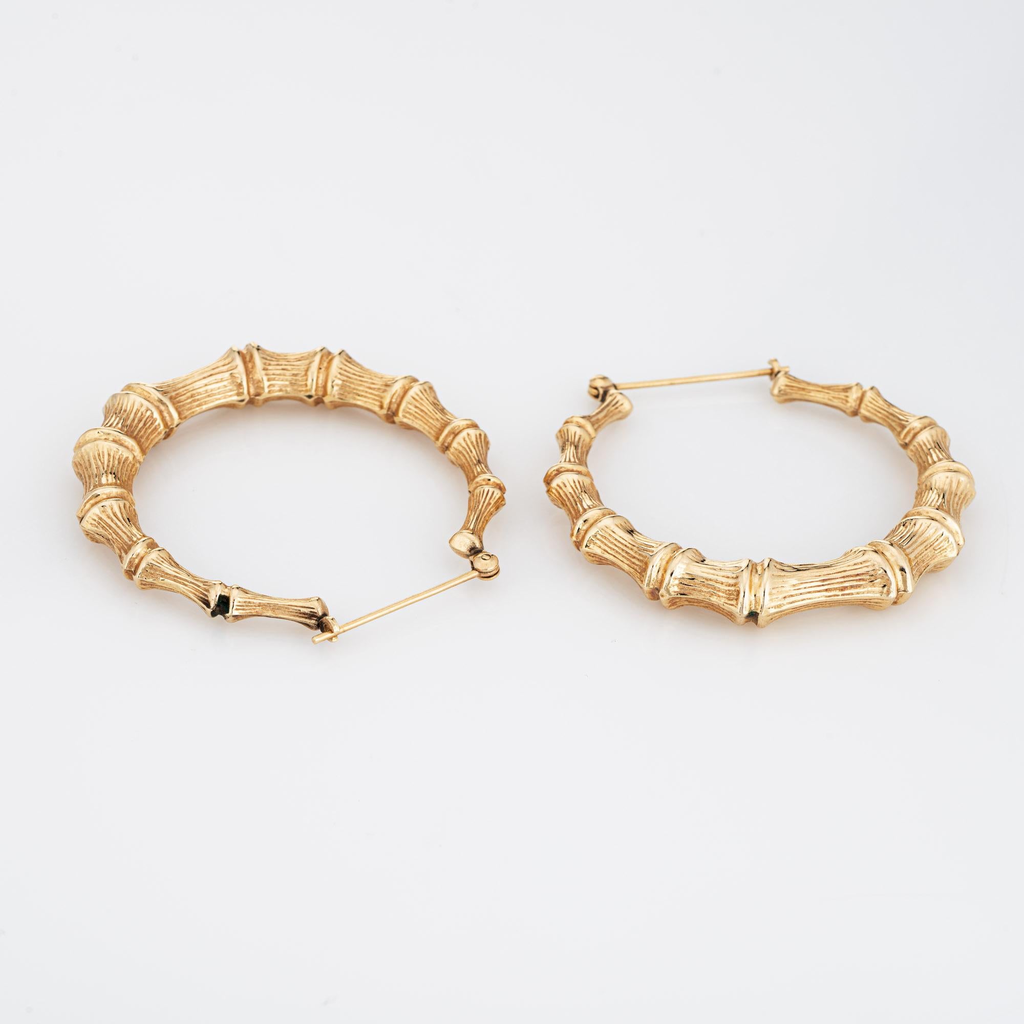 Finely detailed pair of vintage large bamboo earrings crafted in 14k yellow gold. 

The stylish earrings feature a textured bamboo design. Large in scale at 1 1/2 inches, the earrings make a nice statement on the earlobe. The earrings are fitted