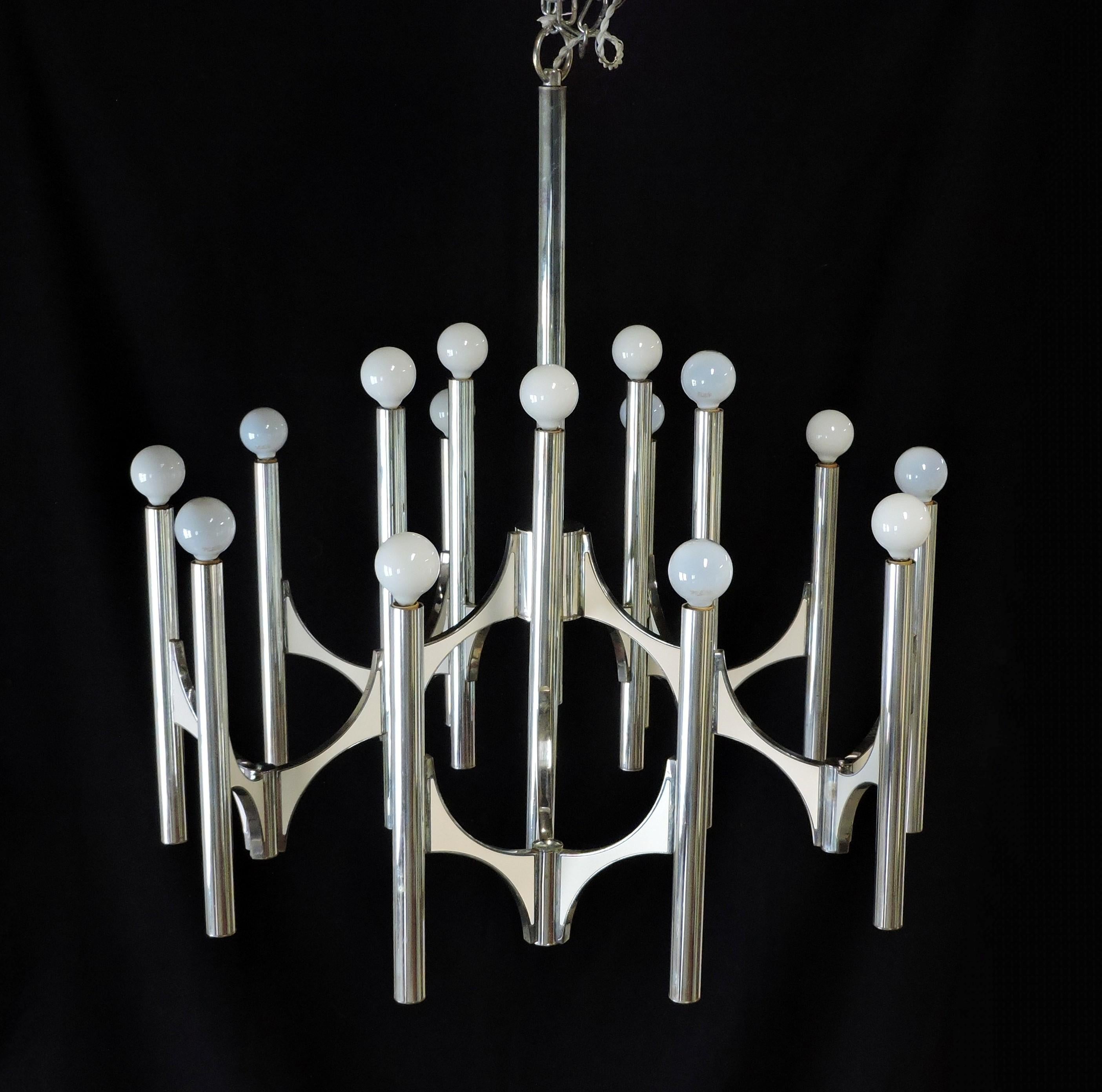 Beautiful and large chandelier designed by Gaetano Sciolari. This impressive 15 light fixture has a chrome finish with contrasting white enameled panels on the arms. The original ceiling cap is included.
Approximately 30 inches in diameter by 30