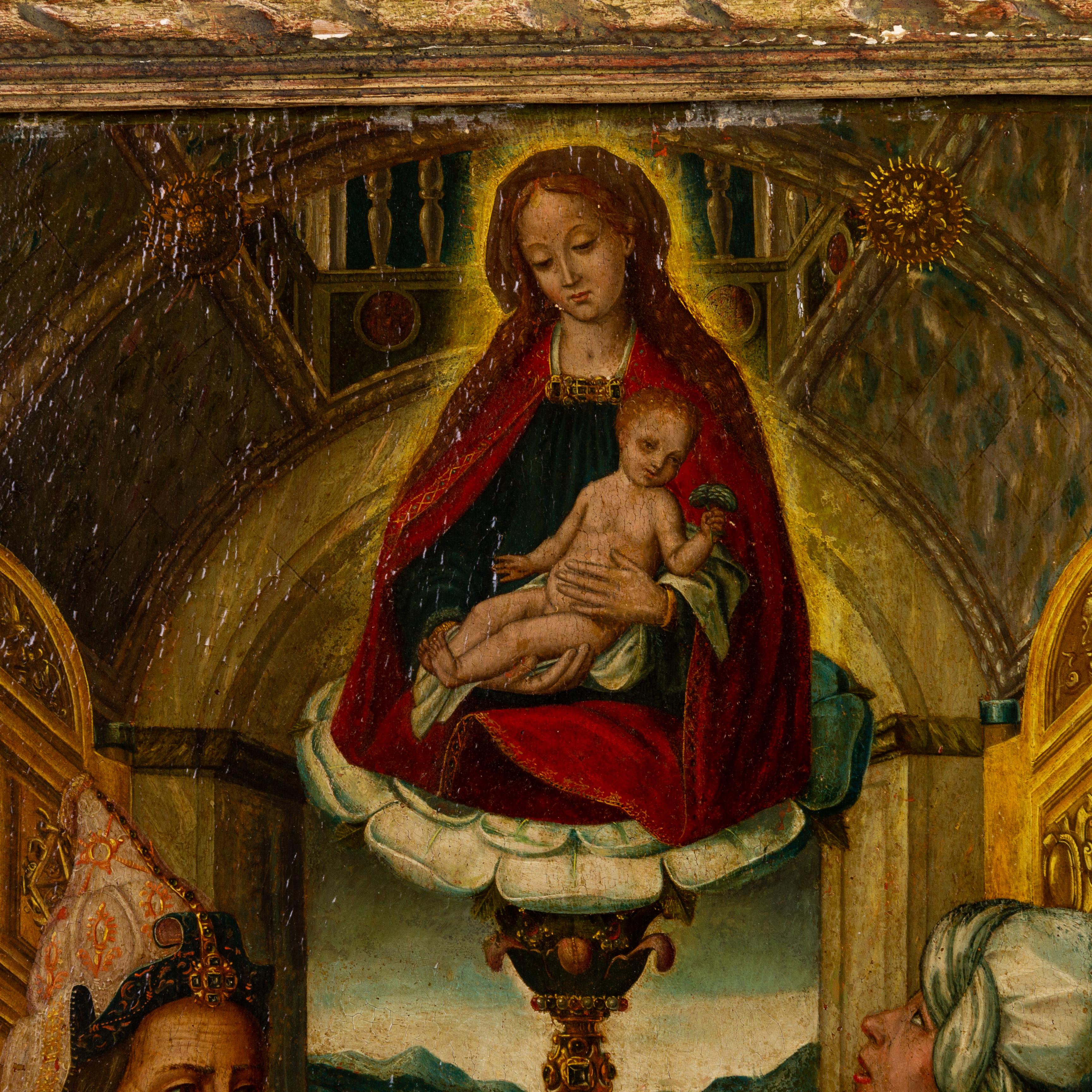 This large 16th century (ca. 1550) Flemish old master oil on panel depicts the divine appearance of the Madonna and Child uniting a royal couple. To the lower left is Saint Anthony, accompanied by a donor to the right, the latter bearing an
