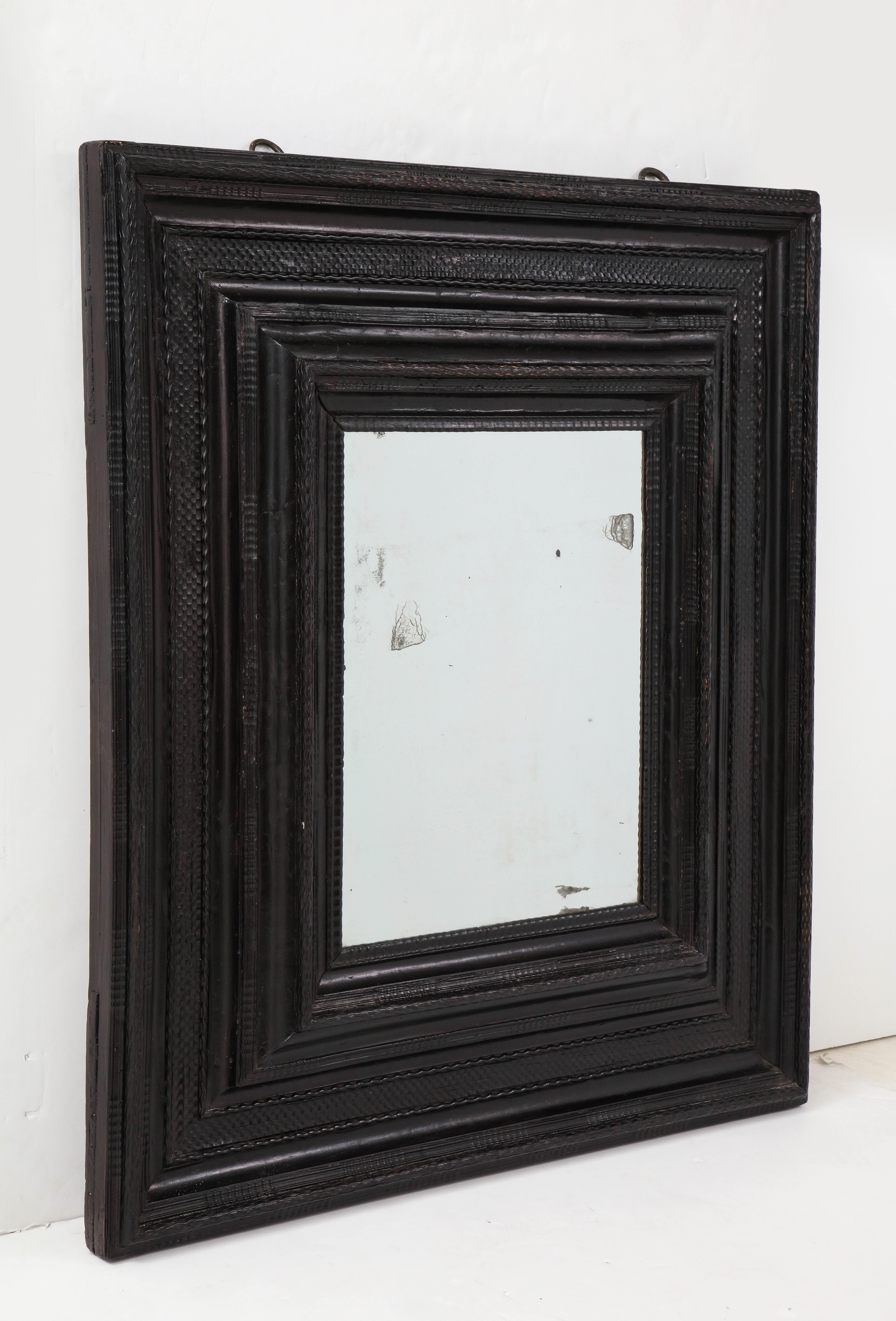 Large 17th C Italian ebonized walnut guilloche mirror with original glass
Walnut, mirrored glass
Measures: H 47.5, W 41.5 in.