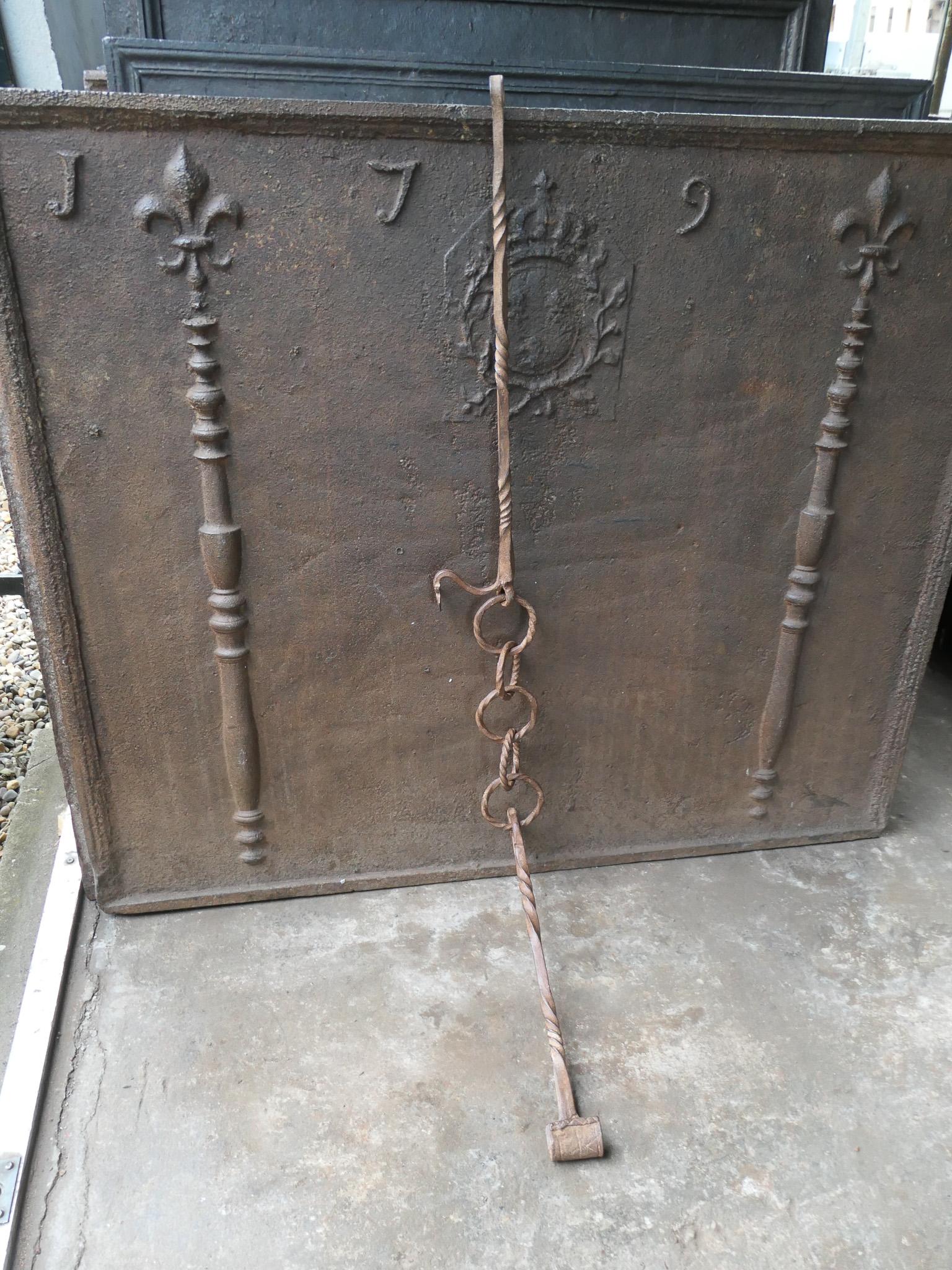 17th century French Louis XIV period fireplace trammel made of wrought iron. 

The trammel was used for cooking to regulate the distance between the pot and the fire. The trammel is still functional.

