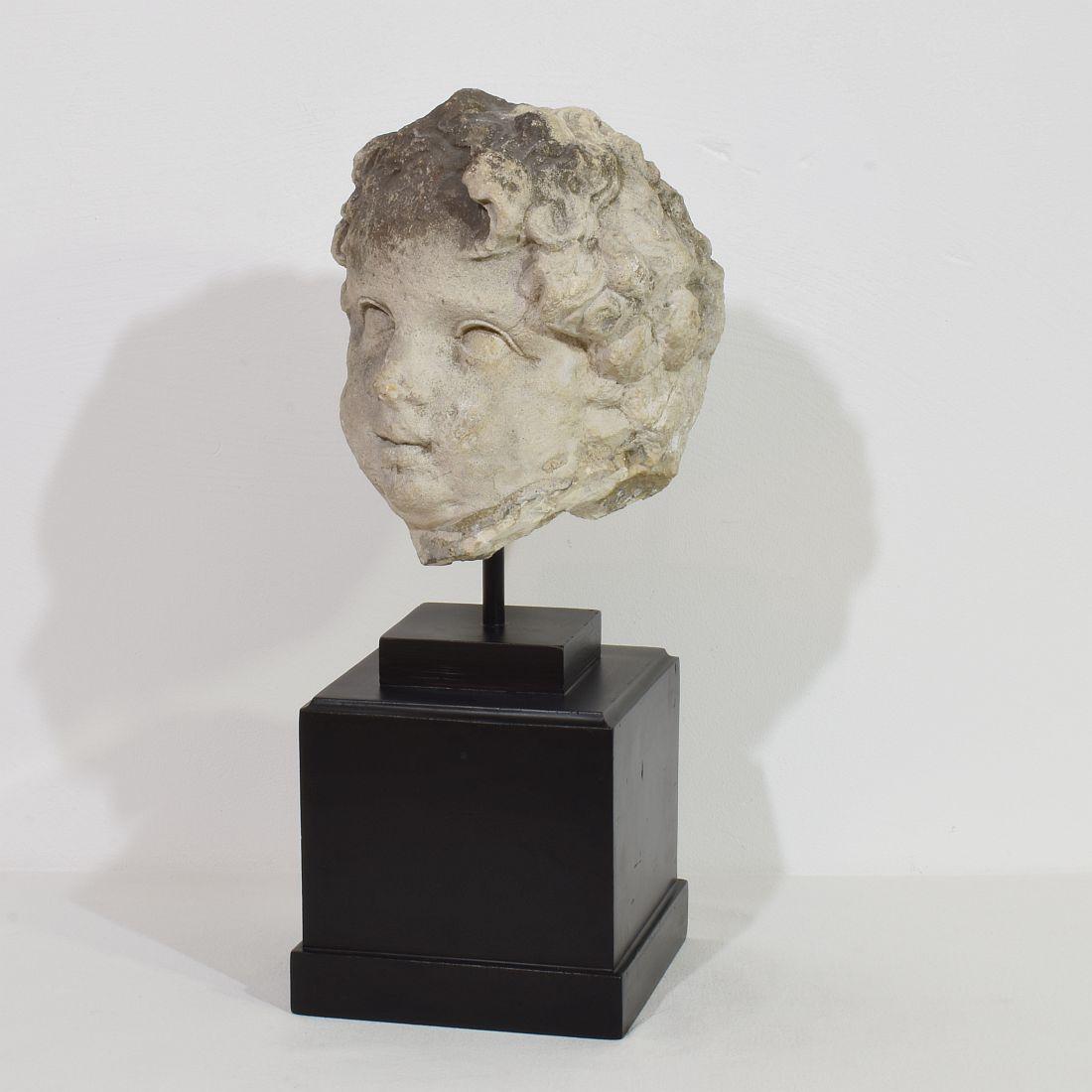 Amazing and large handcarved limestone head with a stunning weathered look. Unique period piece from the 17th century now placed on a wooden pedestal.
France circa 1600-1700. Weathered.
Measurements include the wooden base. Height of the head