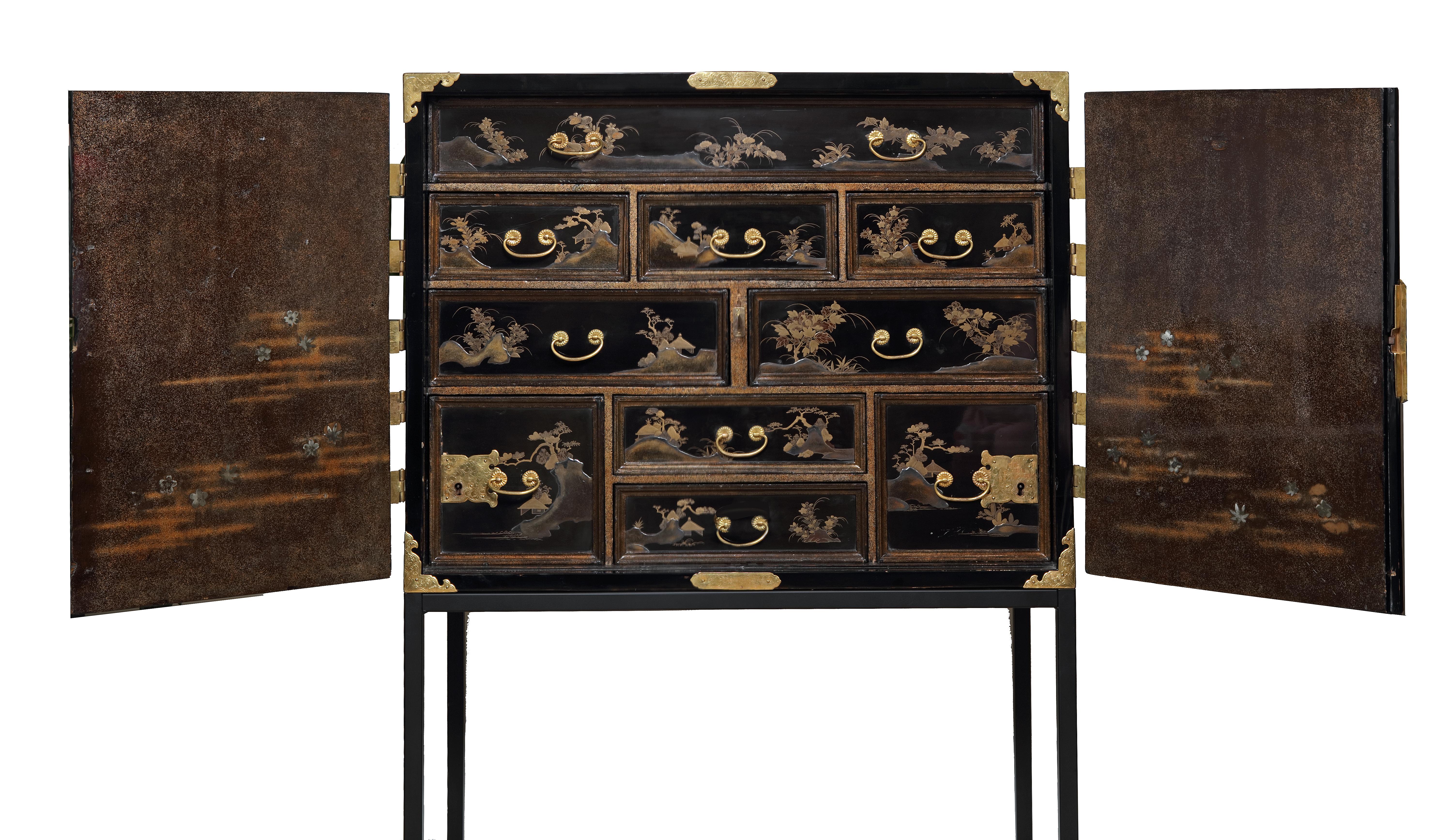 A fine Japanese lacquer cabinet with gilt-copper mounts for the European market

Edo period, late 17th century

The rectangular cabinet with two hinged doors opening to reveal ten various sized drawers, decorated on the doors with a teapot and a