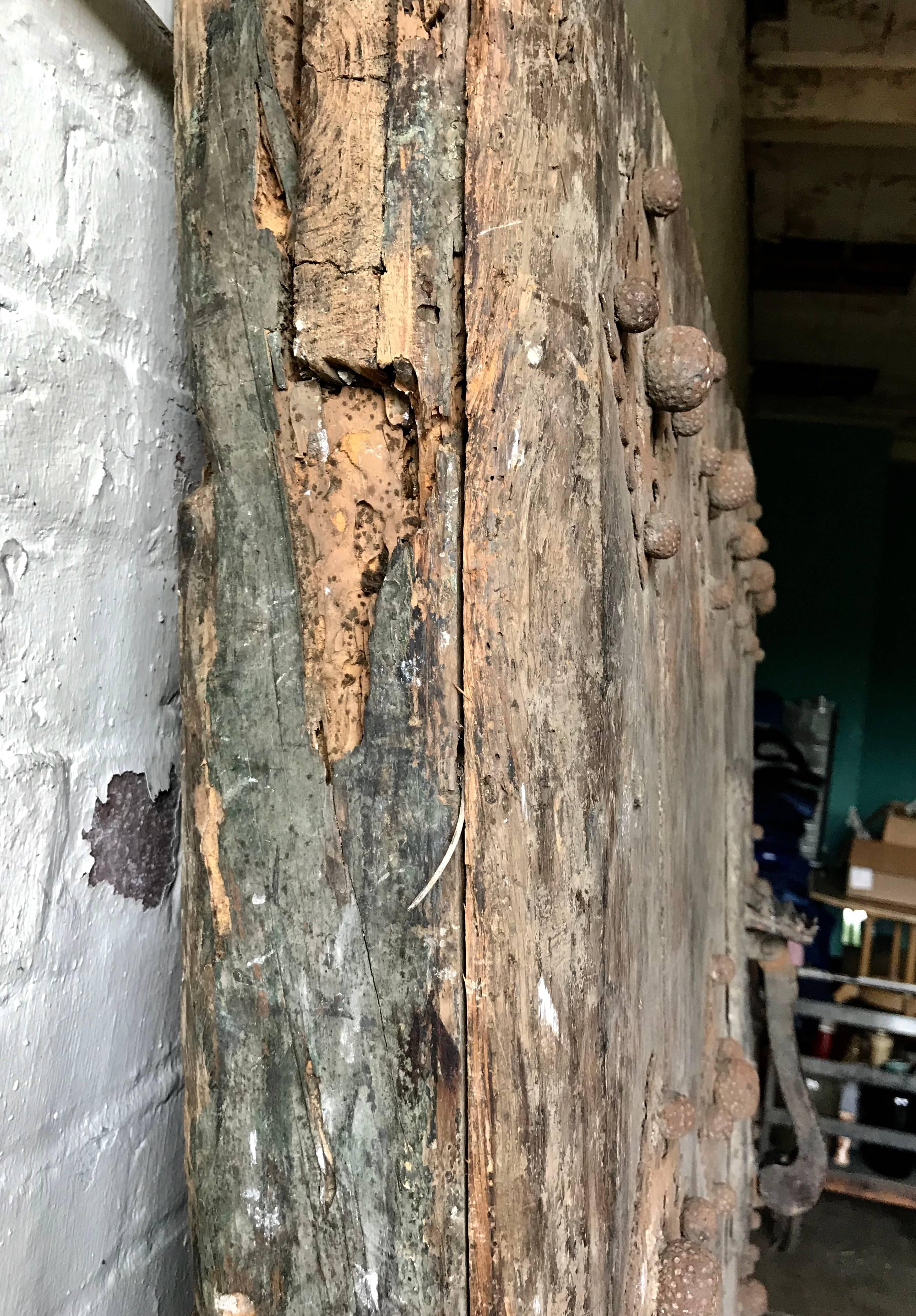 Large 17th Century Spanish Chestnut Wood Door with Iron Hardware In Distressed Condition In Buffalo, NY