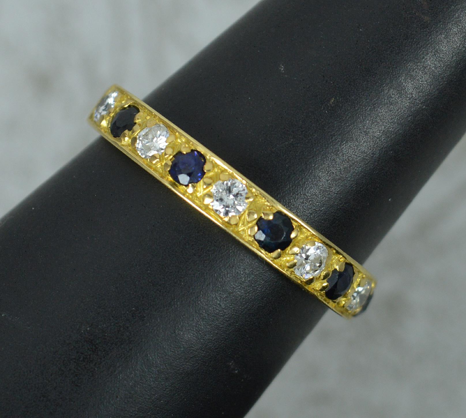 A beautiful half eternity stack ring.
Solid 18 carat yellow gold example.
Designed with alternating round brilliant cut diamonds and blue sapphires.
22mm spread of stones. 3.5mm wide band to front.

CONDITION ; Very good. Crisp design. Well set