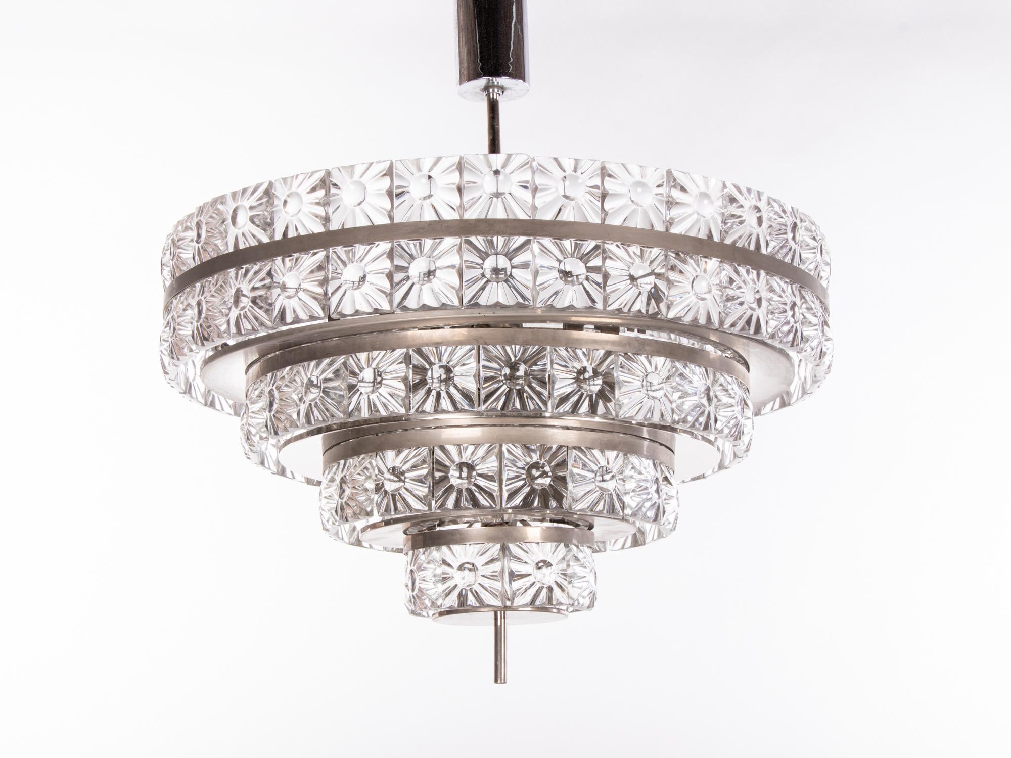 Stunning large five-tier lens chandelier with heavy crystal glass elements on a nickel frame. Crystal glasses resemble magnifying glasses. Has 18 sockets. In very good condition. Chandelier illuminates beautifully and offers a lot of light. Gem from
