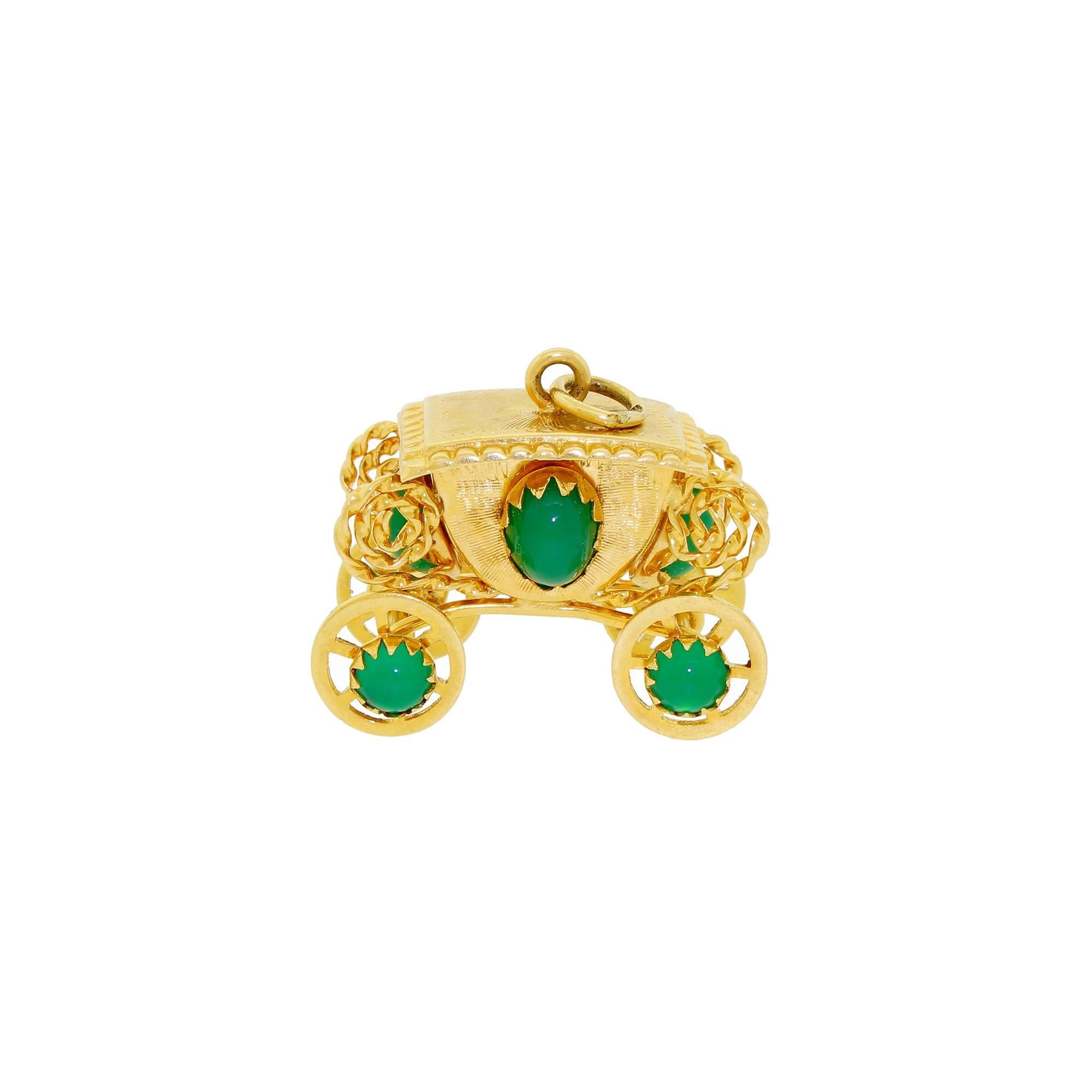 This remarkable 18K gold carriage features eight green art glass beads and mechanical wheels that spin freely. This piece is substantial enough to be worn as a pendant, or utilized as the large end accent piece for a charm bracelet. It is