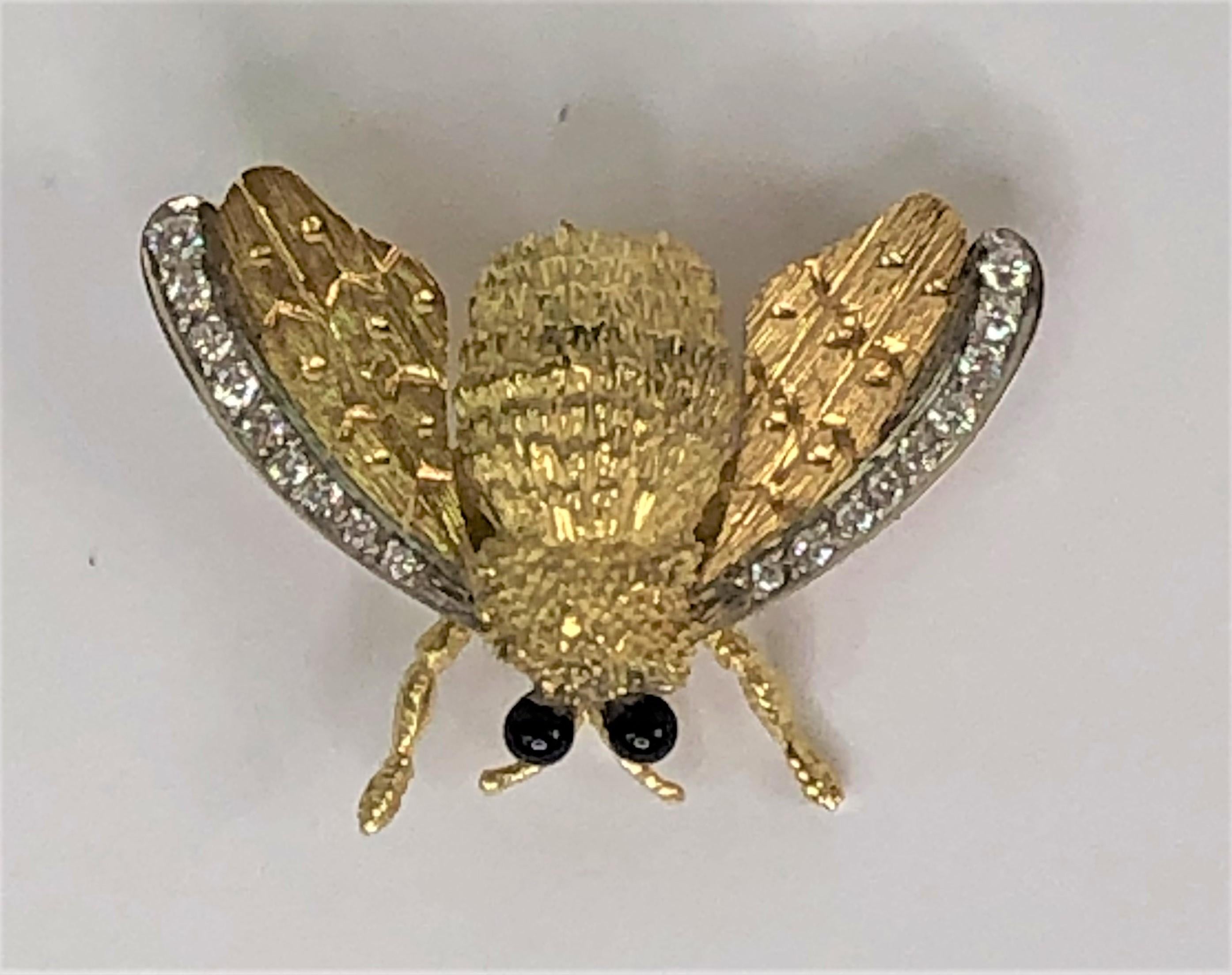 This busy bee sparkles!
18 karat yellow and white gold bee.  Approximately 26mm x 37mm
18 total diamonds line the edge of the wings in 18K white gold.  Approximately .50tdw.
Bee's 