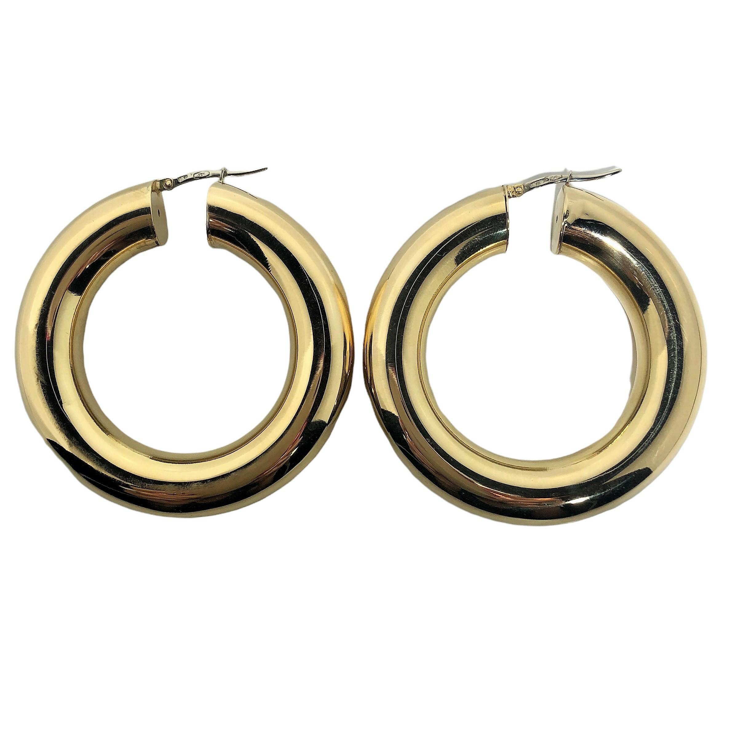 There are an untold number of gold hoop earrings in the world, but this pair absolutely stands alone. Created in Arezzo Italy in 18k yellow gold, they measure a full 2 inches in diameter with with tubing that measures  3/8 inches in diameter. The