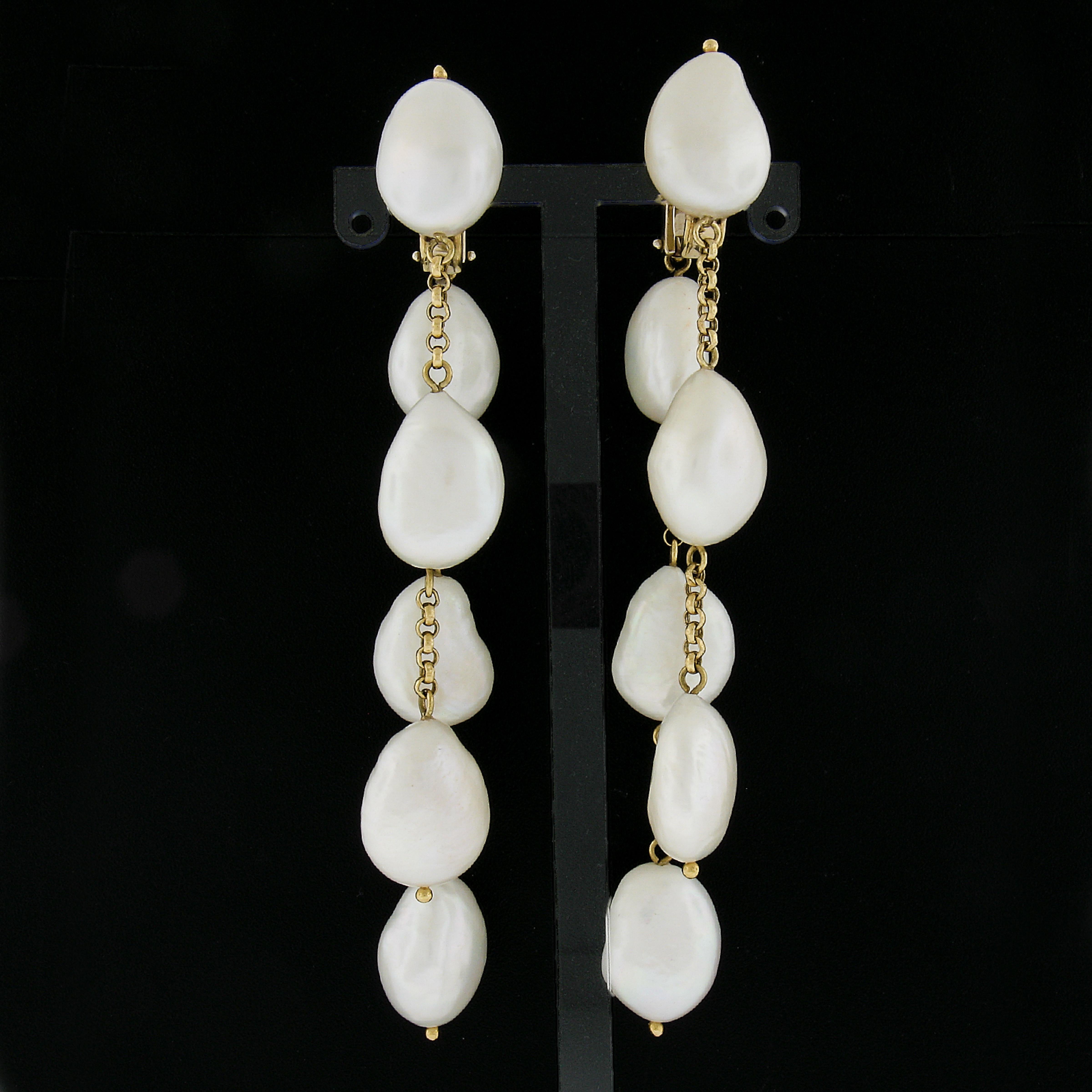 --Stone(s):--
(12) Genuine Cultured Pearls - Baroque Shape - Nice White Color w/ Pink Overtone - Great Luster - 18.4x13.1mm each (approx.)

Material: Solid 18k Yellow Gold w/ White Gold Accents in the Backs
Weight: 41.99 Grams
Backing: Clip On