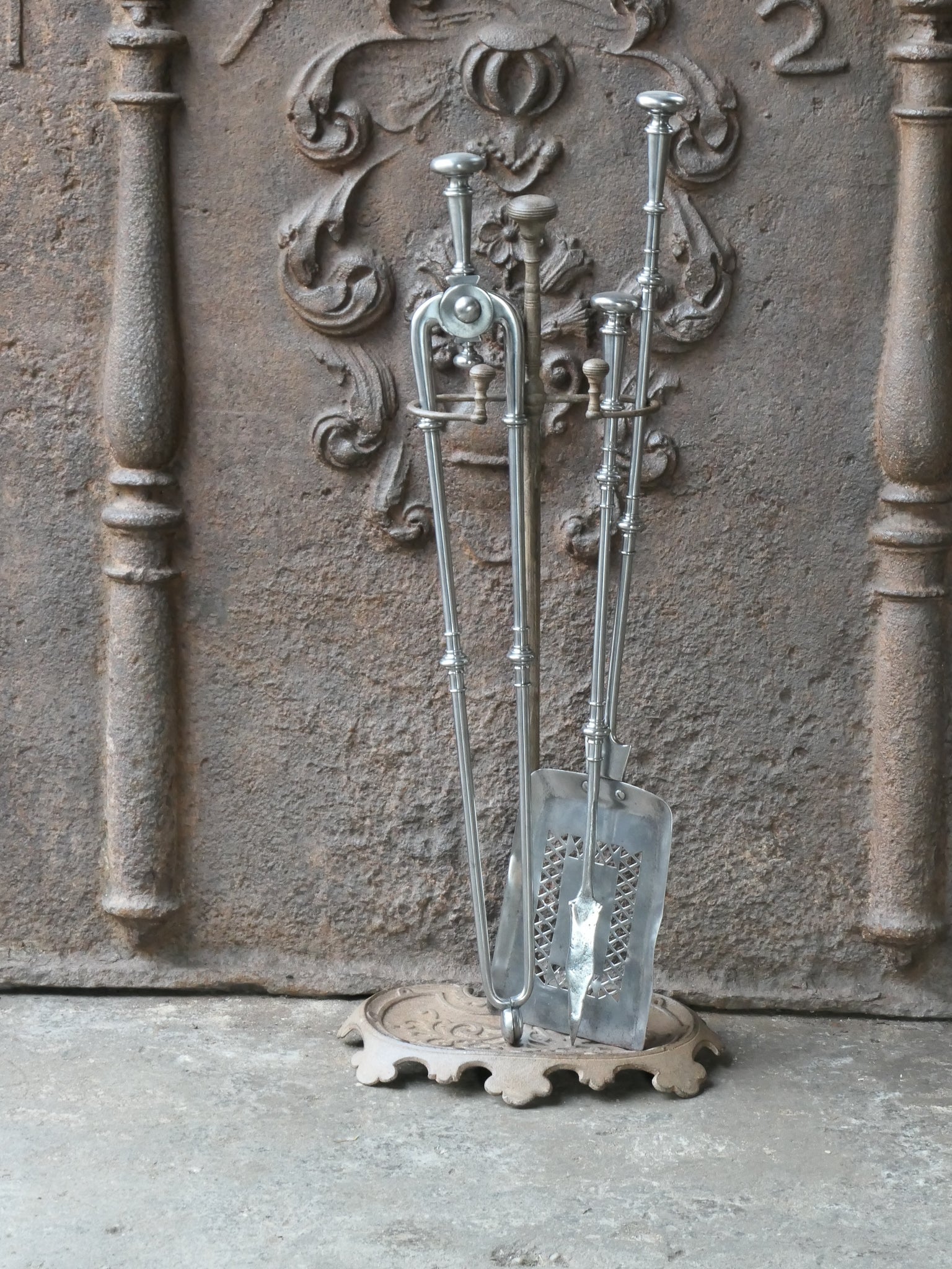 Beautiful 18th - 19th century English Georgian fireplace tool set. The tool set consists of tongs, shovel, poker and stand. The stand is made of cast iron and the tools are made of polished steel. The set is in a good condition and fit for use in