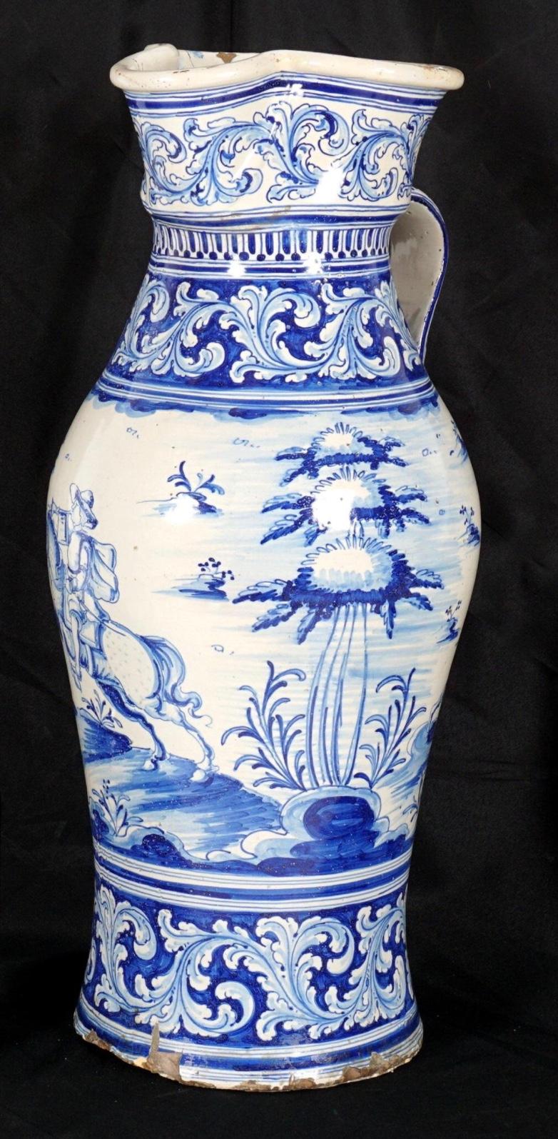 Monumental 18th/19th Century French Blue and White Faience Pitcher. Large blue and white faience decorated water pitcher / vessel, foliate scroll bands and hunting genre scenes, shaped rim, applied handle. Bright vivid colors throughout.