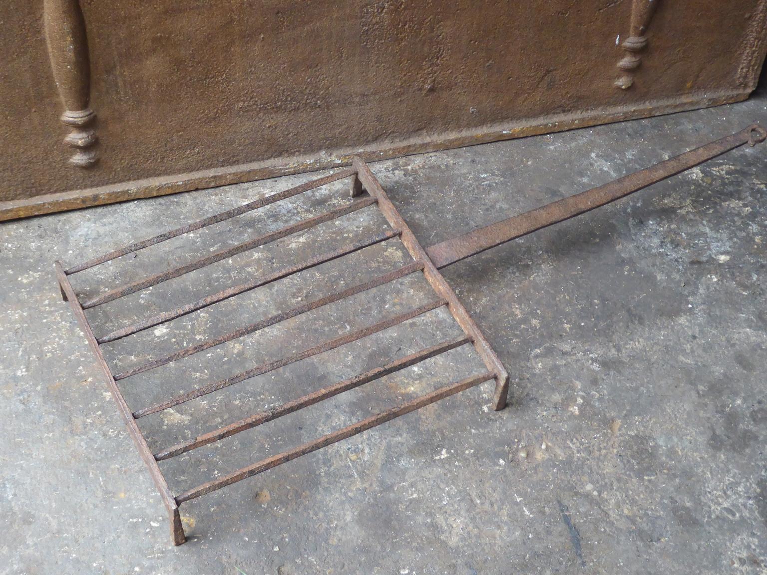 Large 18th-19th century French gridiron made of wrought iron. The gridiron was used for cooking in the fireplace. It can still be used to grill food in your fireplace very easily.







                        