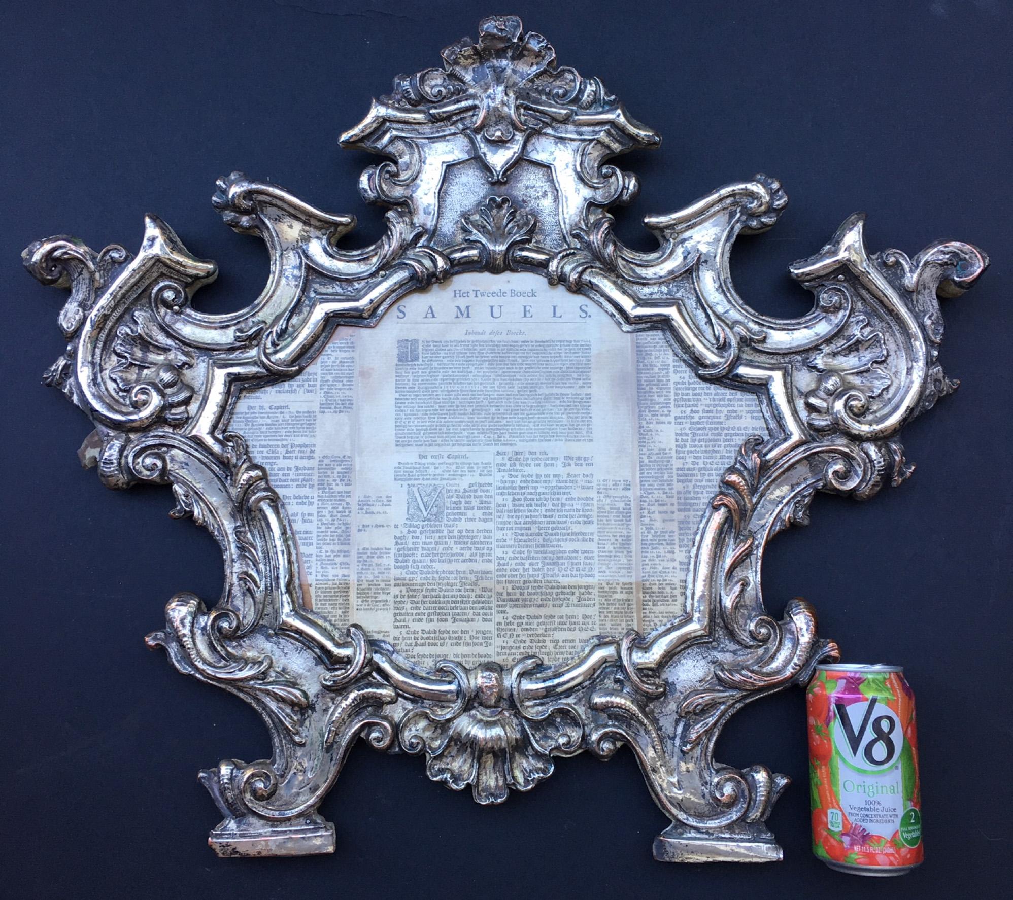 This original 18th century frame is silver gilded over copper. It is elaborately embossed and chiseled. The cartouche is surrounded by rocaille and volute motifs. The Carta is mounted on a wood backing and rests on two linear bases. The silver is