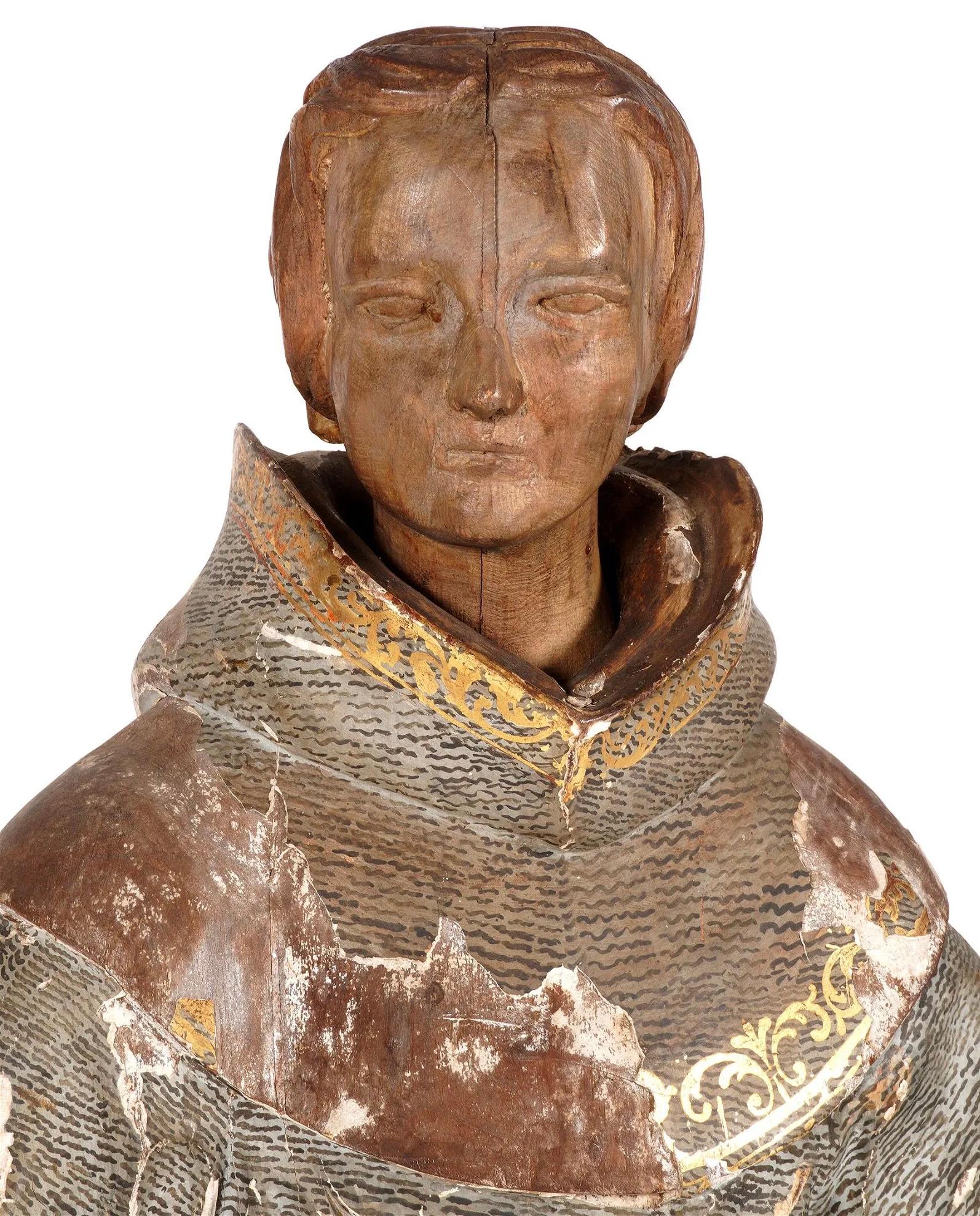 Large 18th century carved Santos. Large figure of robed monk, unpainted head, grey and white painted robe with gilt accents, feet peaking out from robe. Wonderful old chippy peeling patina. 

Measures: Overall 42.25