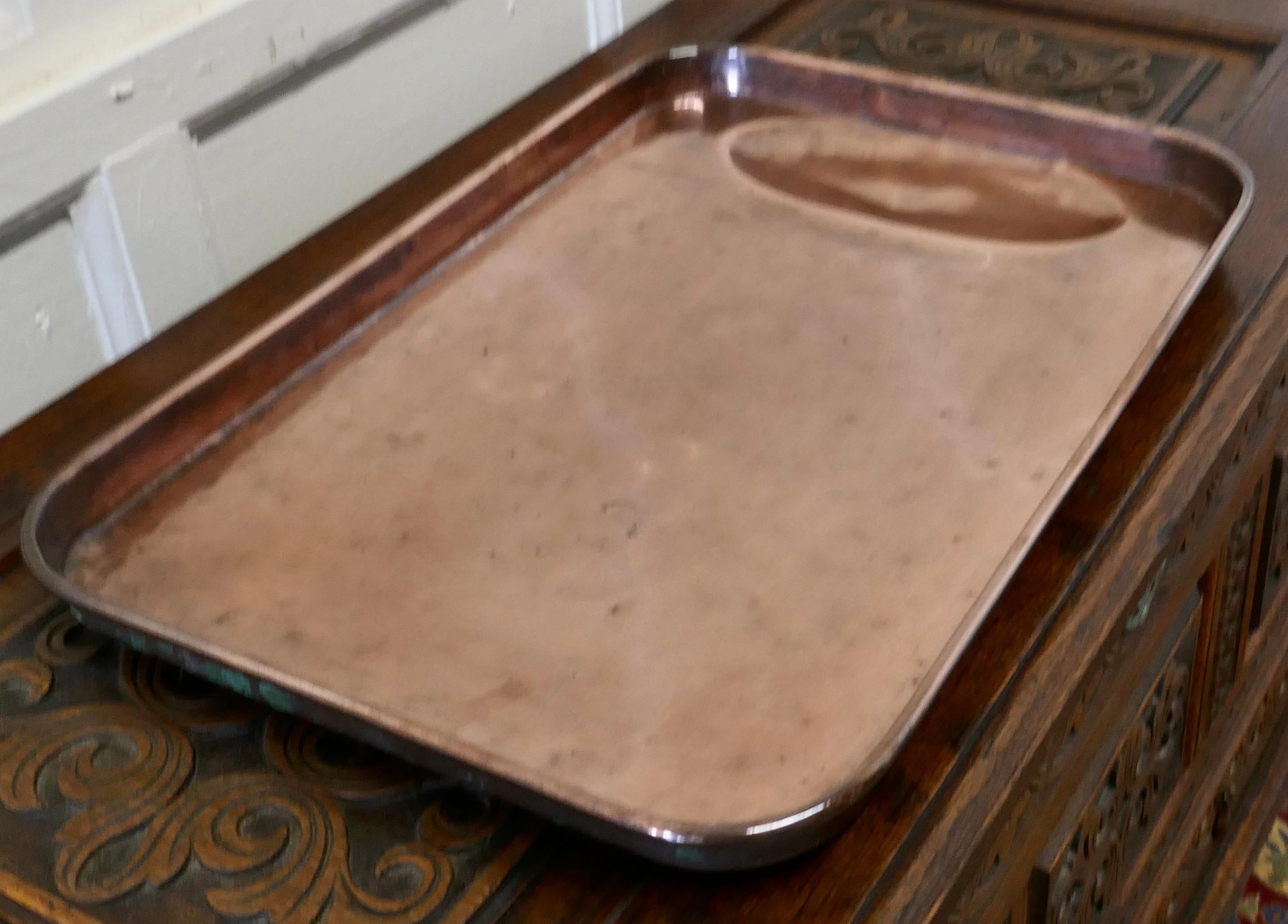 Large 18th Century Copper Roasting Tray with Gravy Well

This is a lovely looking piece of Copper cookware, the tray is very rare and would have been much treasured piece
The tray has 1.5” high sides with a rolled top edge and an oval gravy
well at